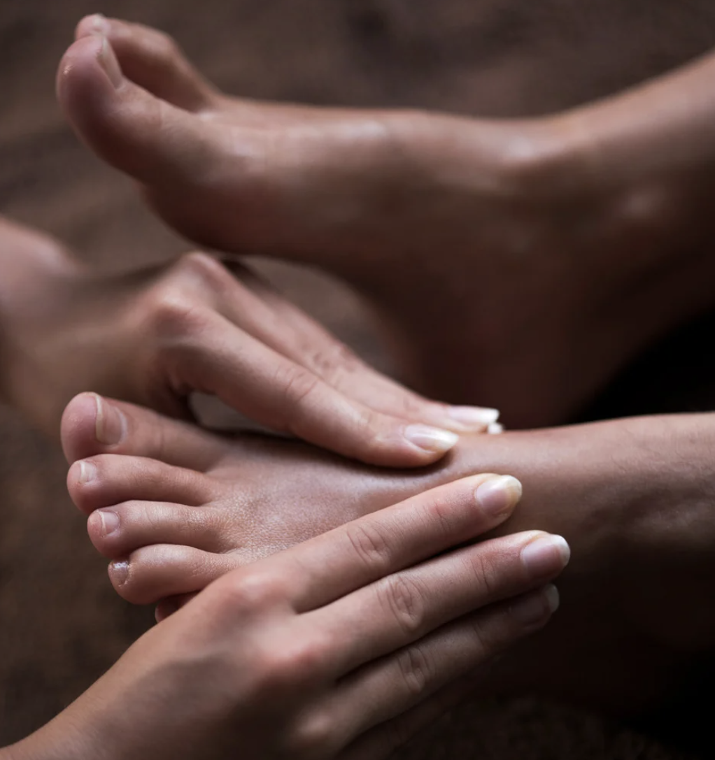 Close-up of hands gently touching in a caring gesture.