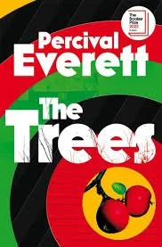 Book cover for 'The Trees' by Percival Everett featuring red, green, black, and white colors with a yellow circle containing three red and green trees or fruit illustrations.