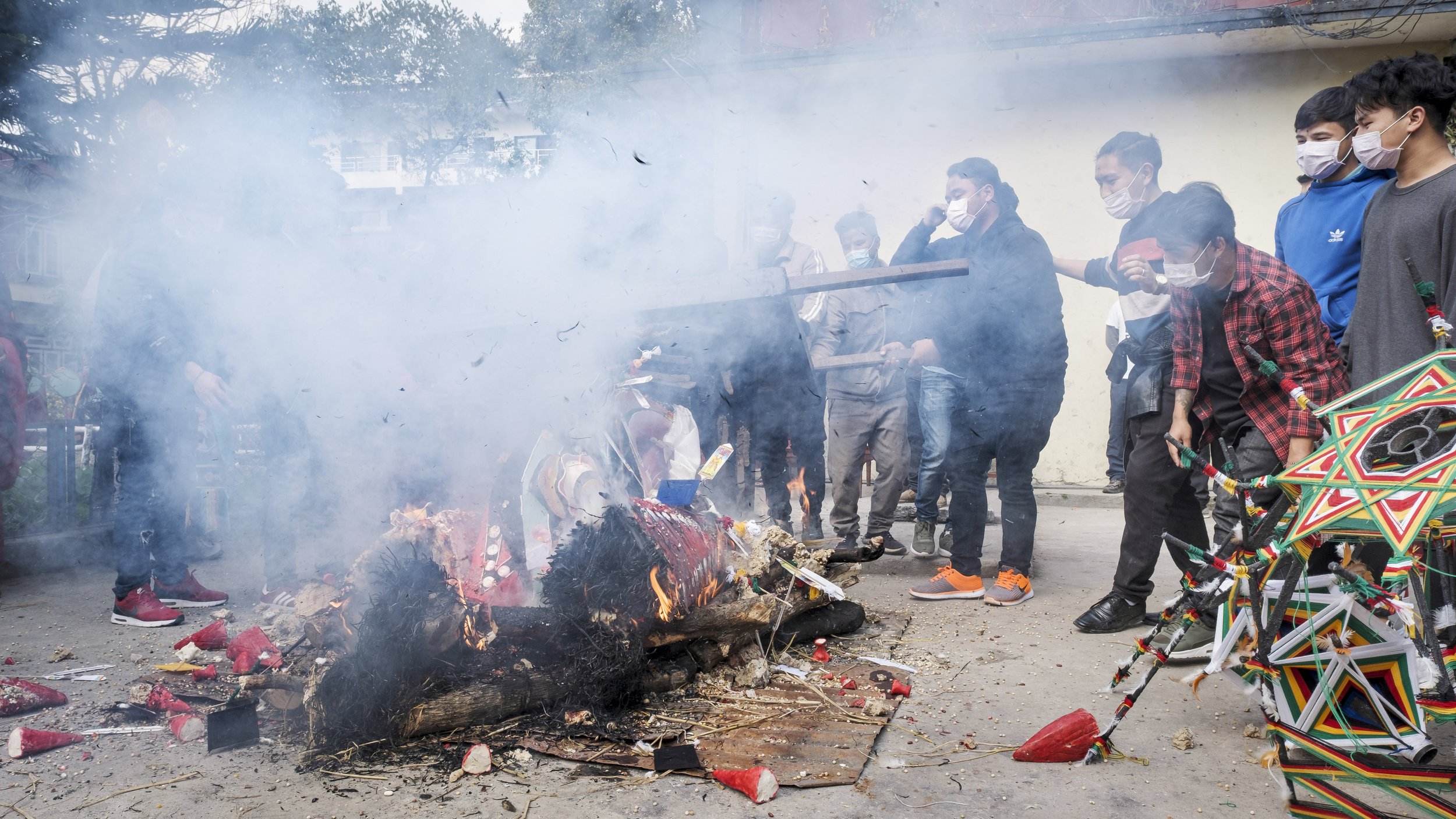 Community members and monks burning the Mahakala torma during the Gutor Chenmo ritual symbolizing purification and impermanence in Kathmandu.