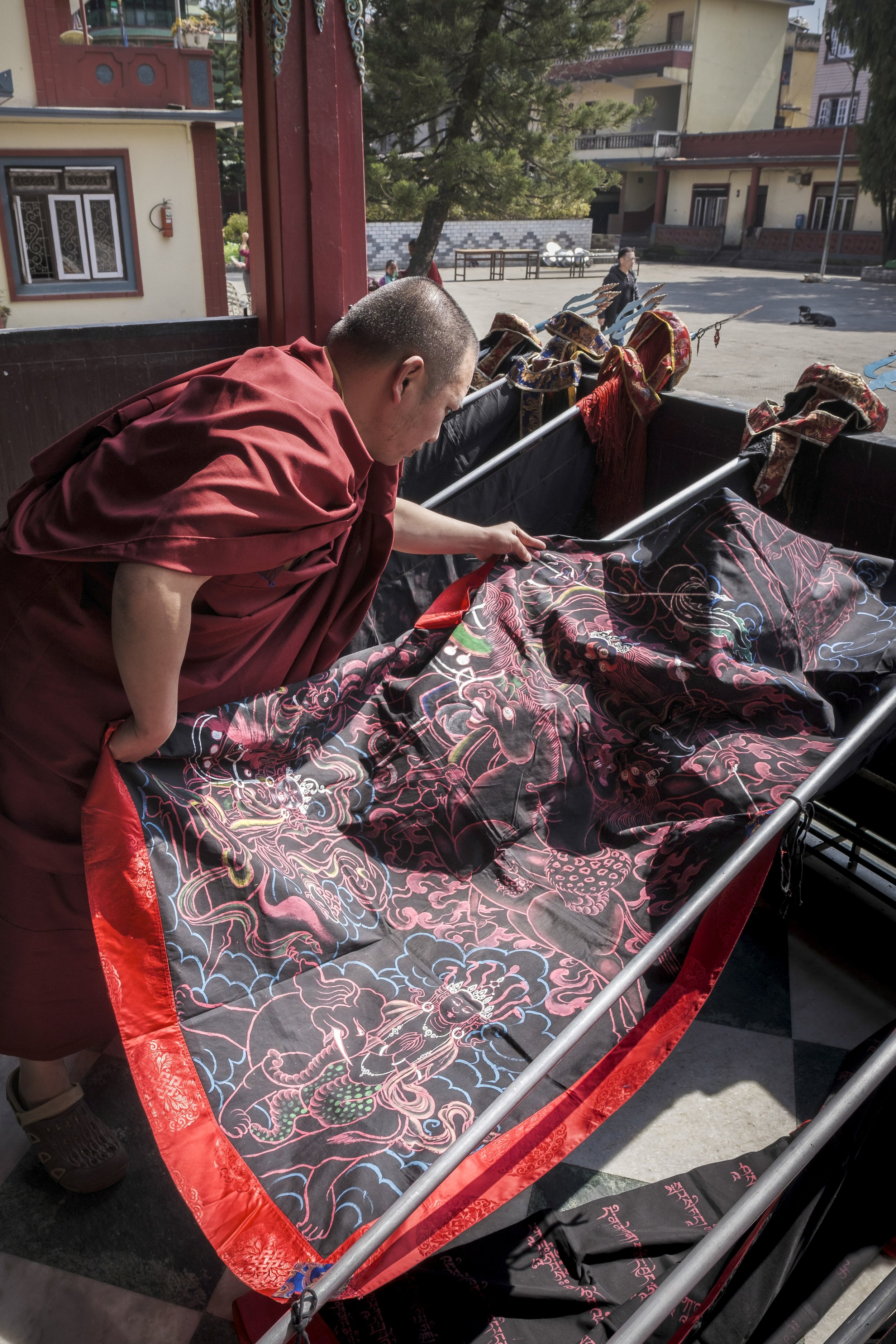 Monk preparing ceremonial flag used in Gutor Chenmo ritual at Pal Dilyag Monastery in Kathmandu.