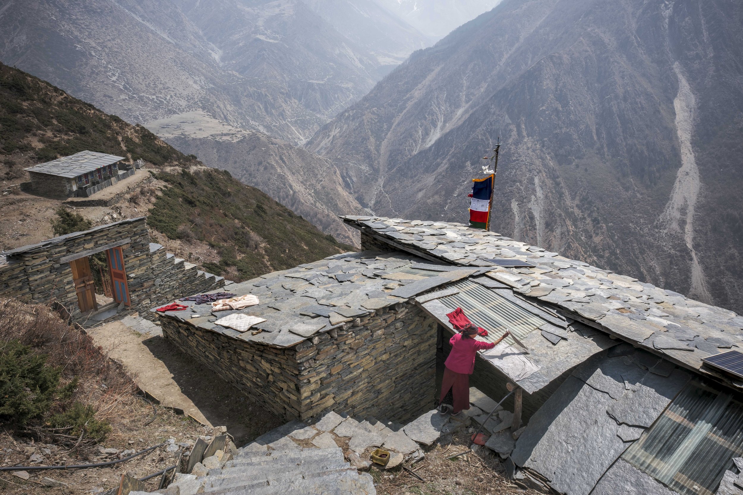 High on the stone-slabbed roof of Dhephu Doma also known as Deren Nunnery, Ani Bhuti spreads her maroon robes to dry in the mountain wind. Alone, she tends to every task — offering butter lamps and bowls of water, sweeping and caring for the chambers