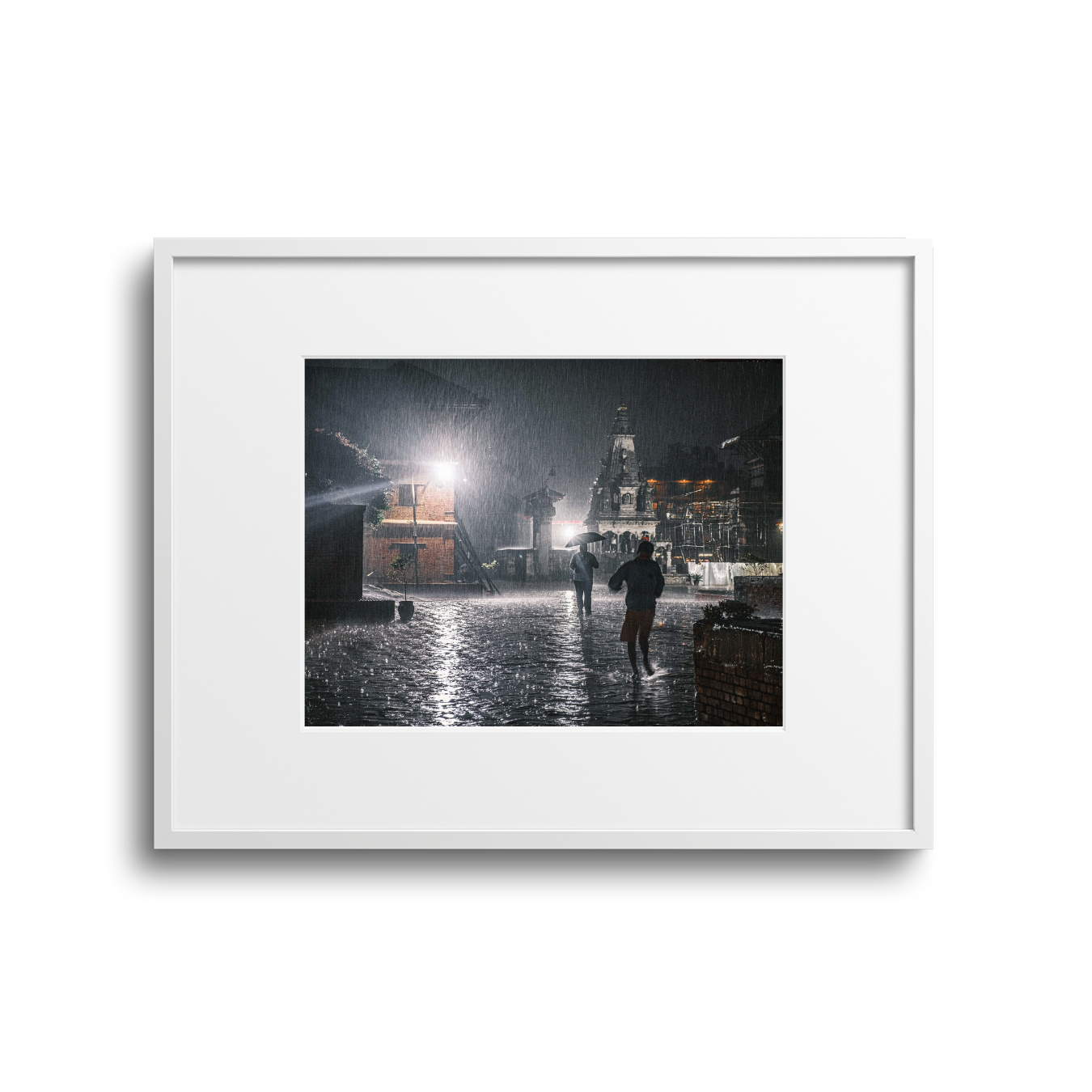People walking during heavy rain at night with a church in the background.