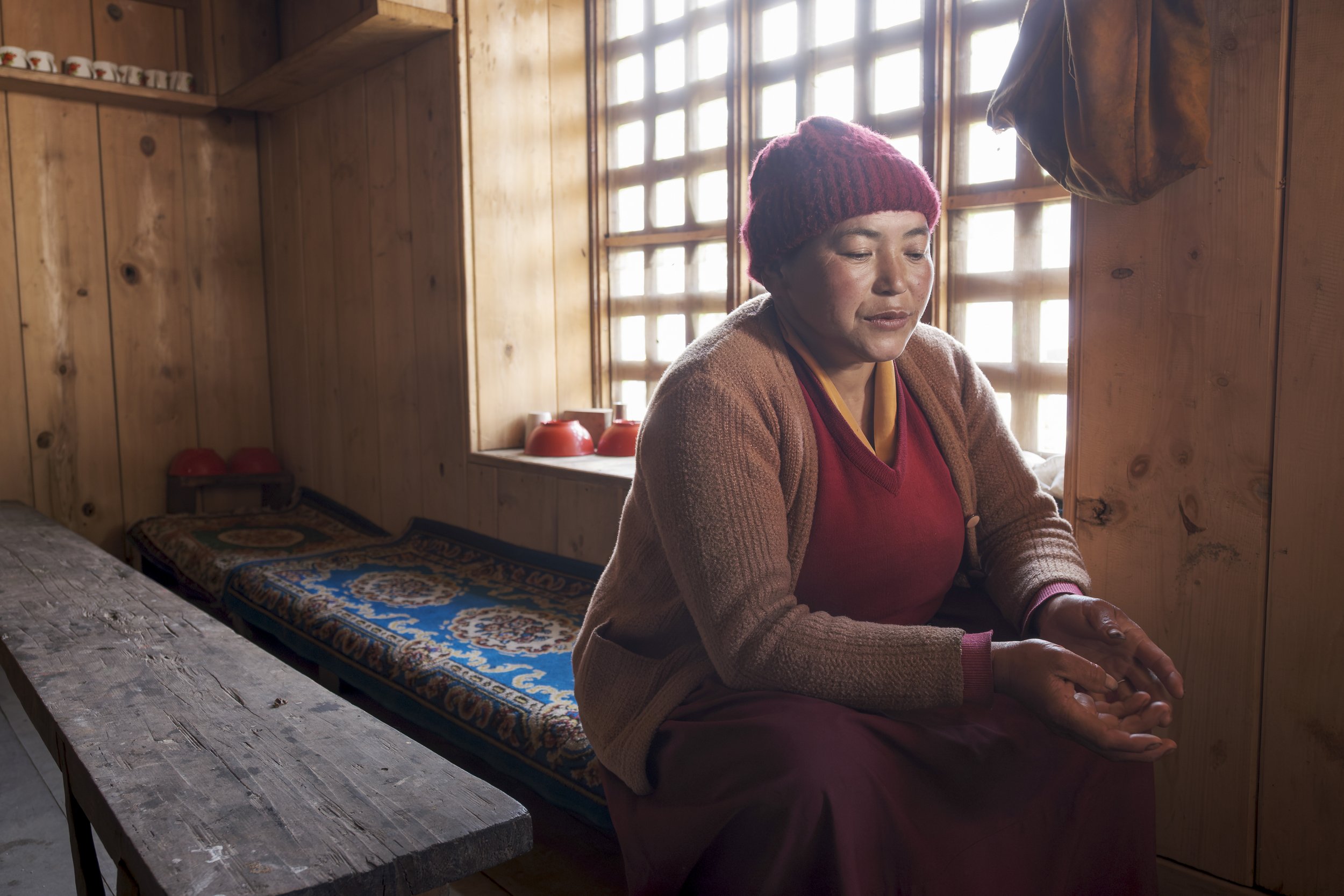 Ani Risang, in her late thirties, is the youngest nun of Gompa Lungtang. She carries the responsibility of the nunnery with unshakable strength, overseeing its daily prayers, tending to its upkeep, and caring tenderly for the older nuns. Though the m