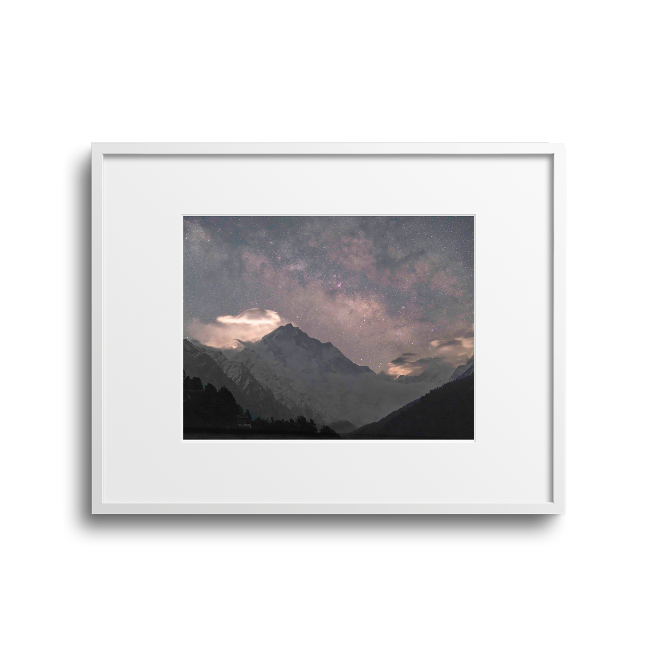 Nighttime mountain landscape with starry sky, rugged snow-capped peaks, and clouds.