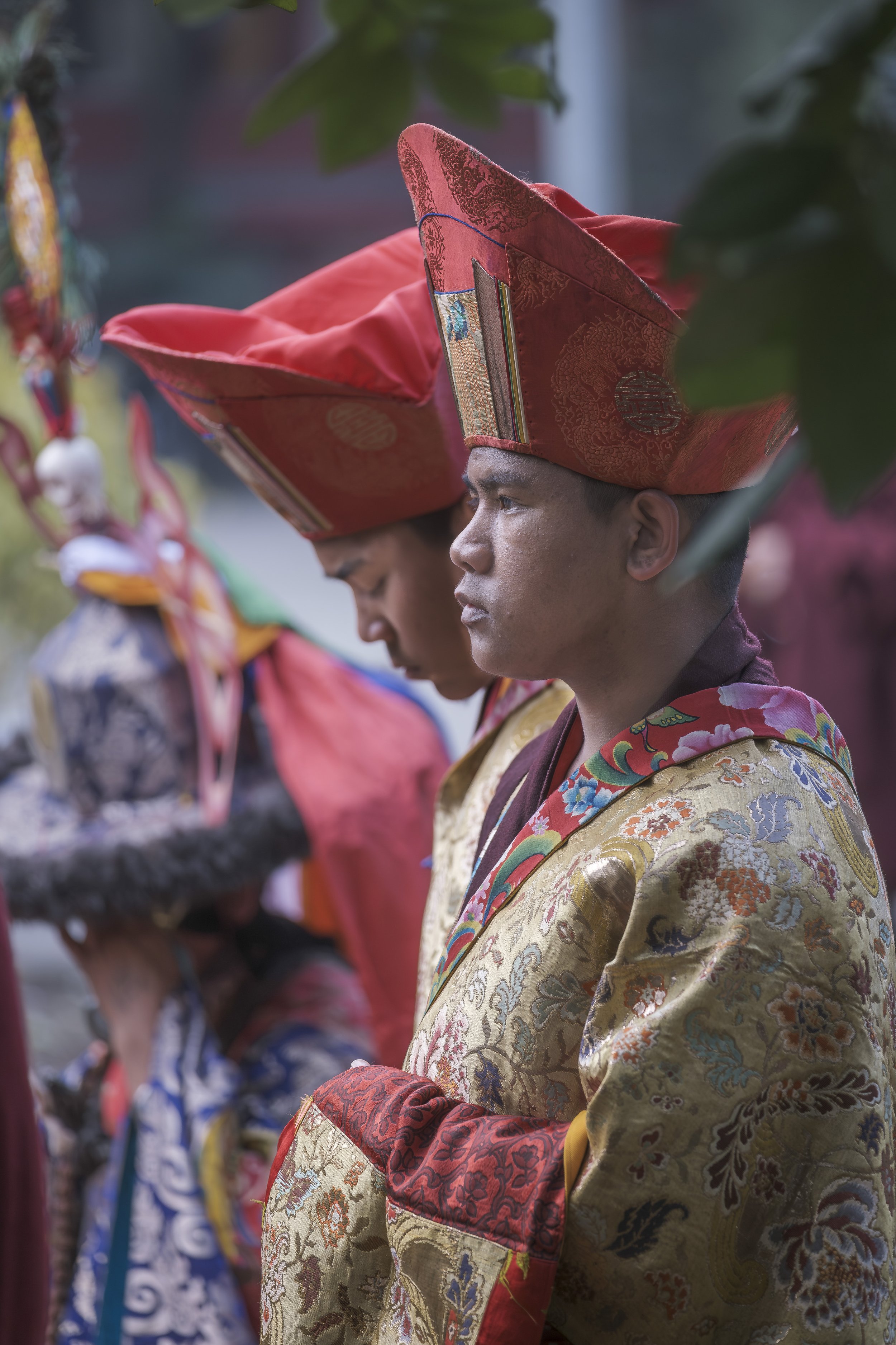 Tibetan monks in traditional ceremonial dress during Gutor Chenmo ritual at Pal Dilyag Monastery in Boudhanath, Kathmandu.
