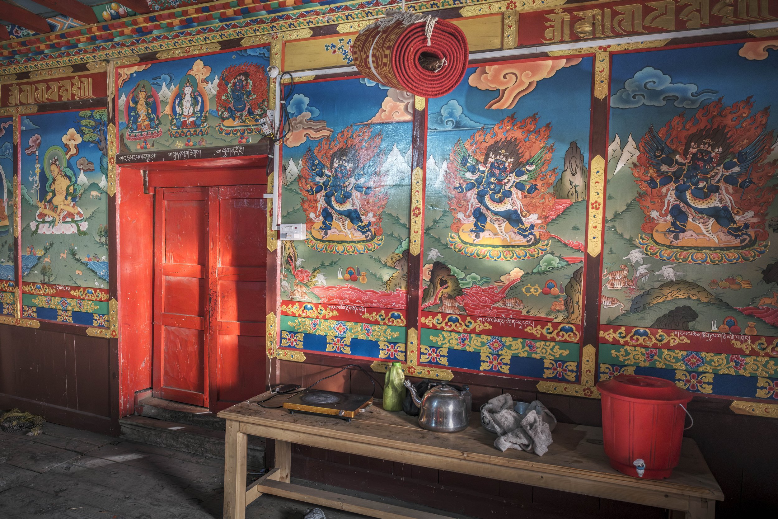 Interior wall paintings of Buddhist deities inside a community monastery in Tsum Valley, Nepal.