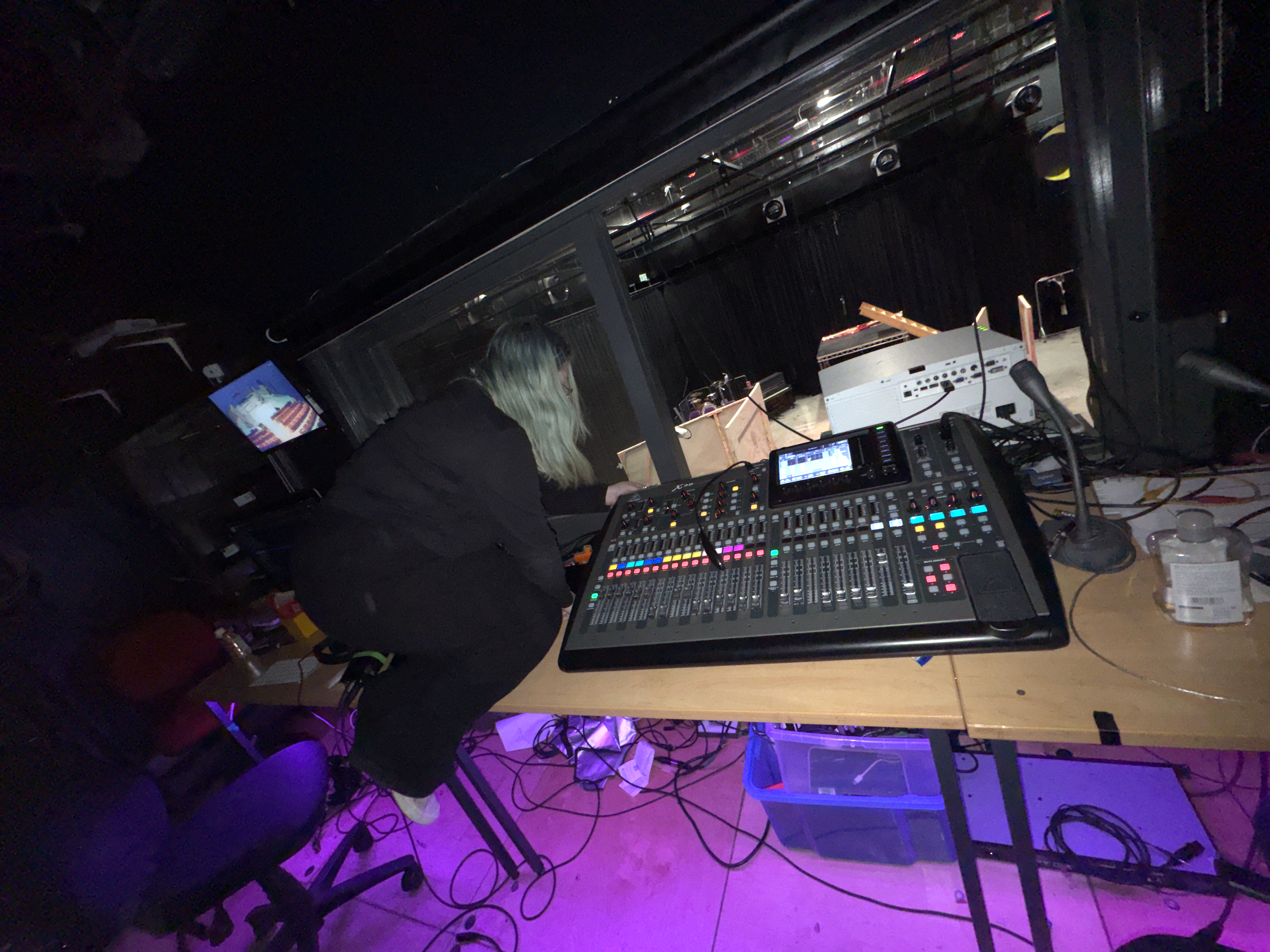 In this picture, I'm changing out the auxiliary cables on the back of the mixer - due to one of them having failed leading to us having no sound from the iMac.