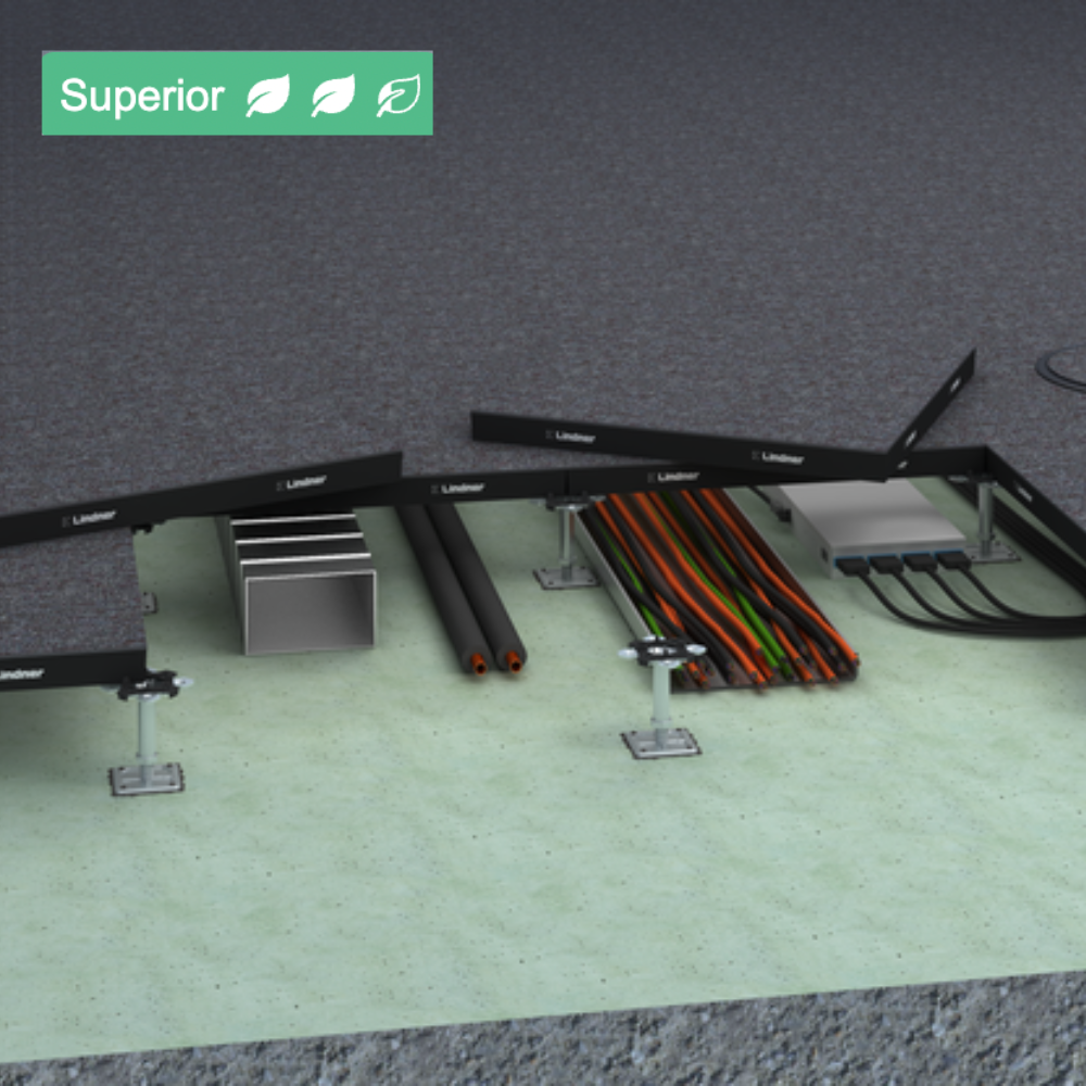 Close-up of electrical cables and wiring components installed on a floor, with a textured wall background.