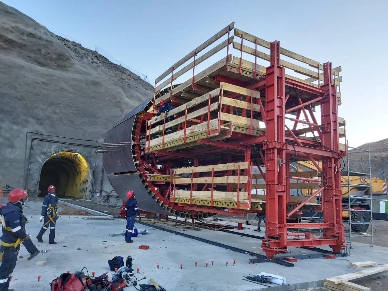 Workers at a construction site assembling a tunnel boring machine.