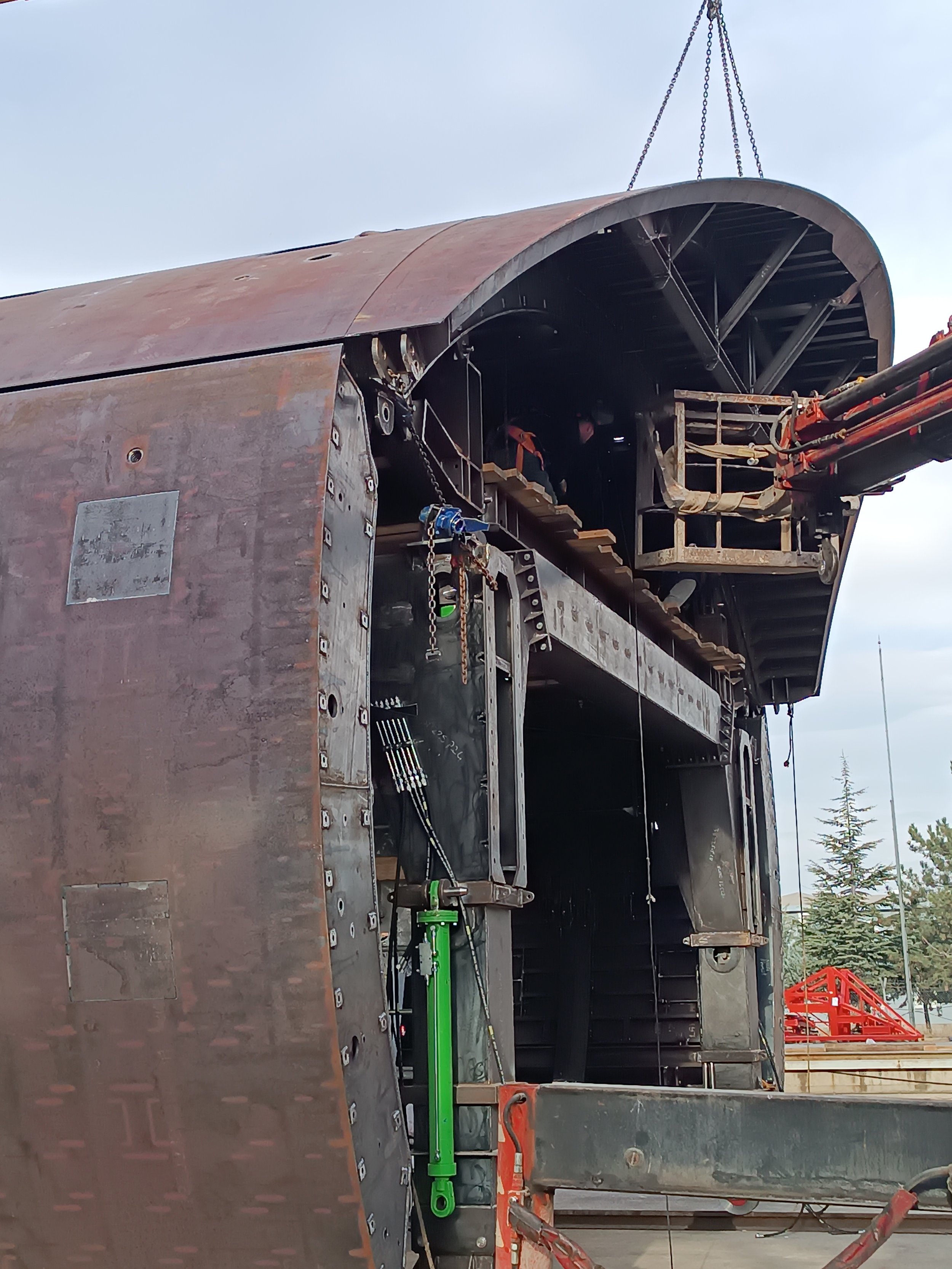 Close-up view of an aircraft's cockpit undergoing maintenance, showing the interior with tools and workers inside.