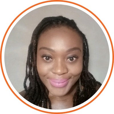 Close-up of a smiling woman with dreadlocks, wearing makeup, against a plain background, framed by a circular border.