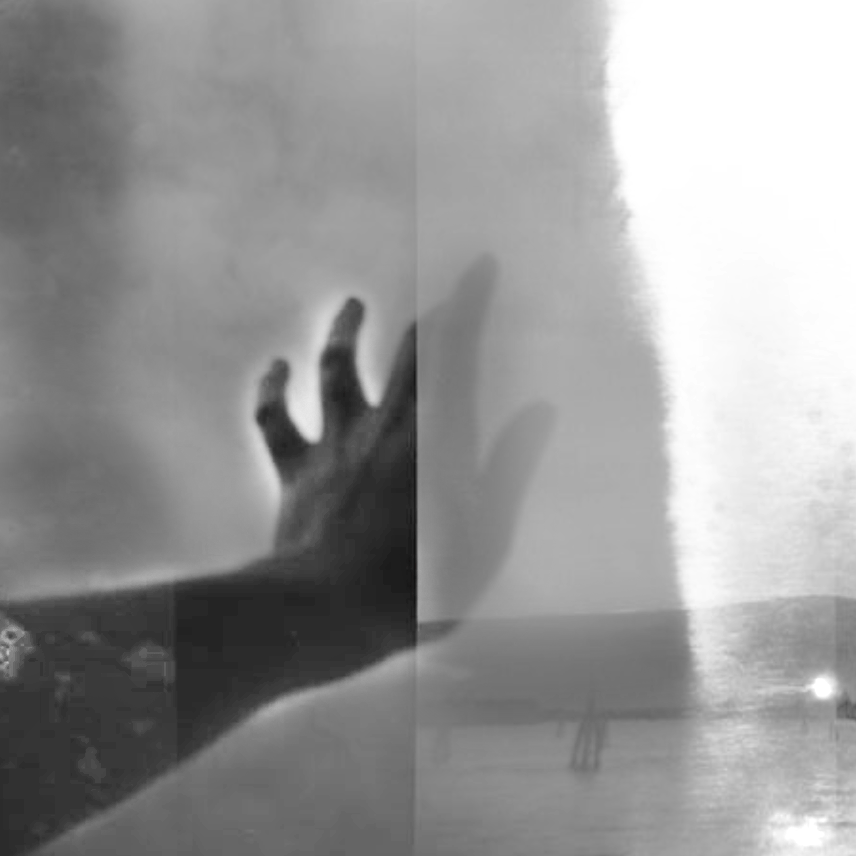 A hand with fingers spread, casting a shadow on a reflective surface, likely a window or glass panel, in black and white.