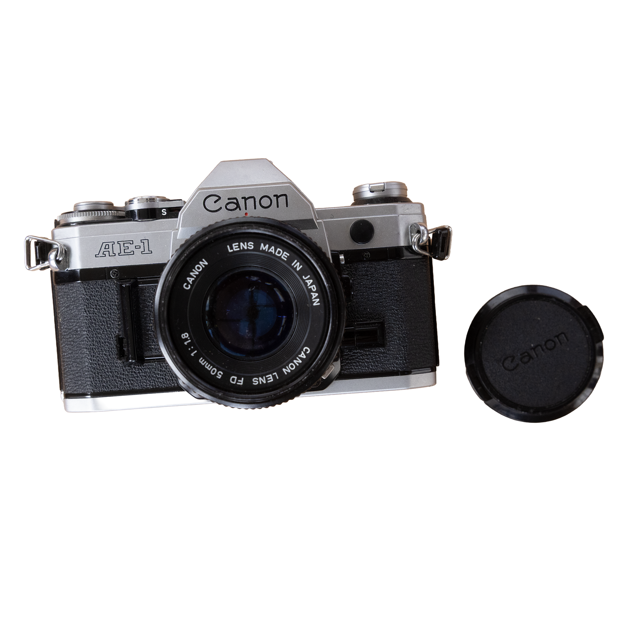 A vintage silver and black Canon AE-1 film camera with a 50mm lens and a Canon lens cap.
