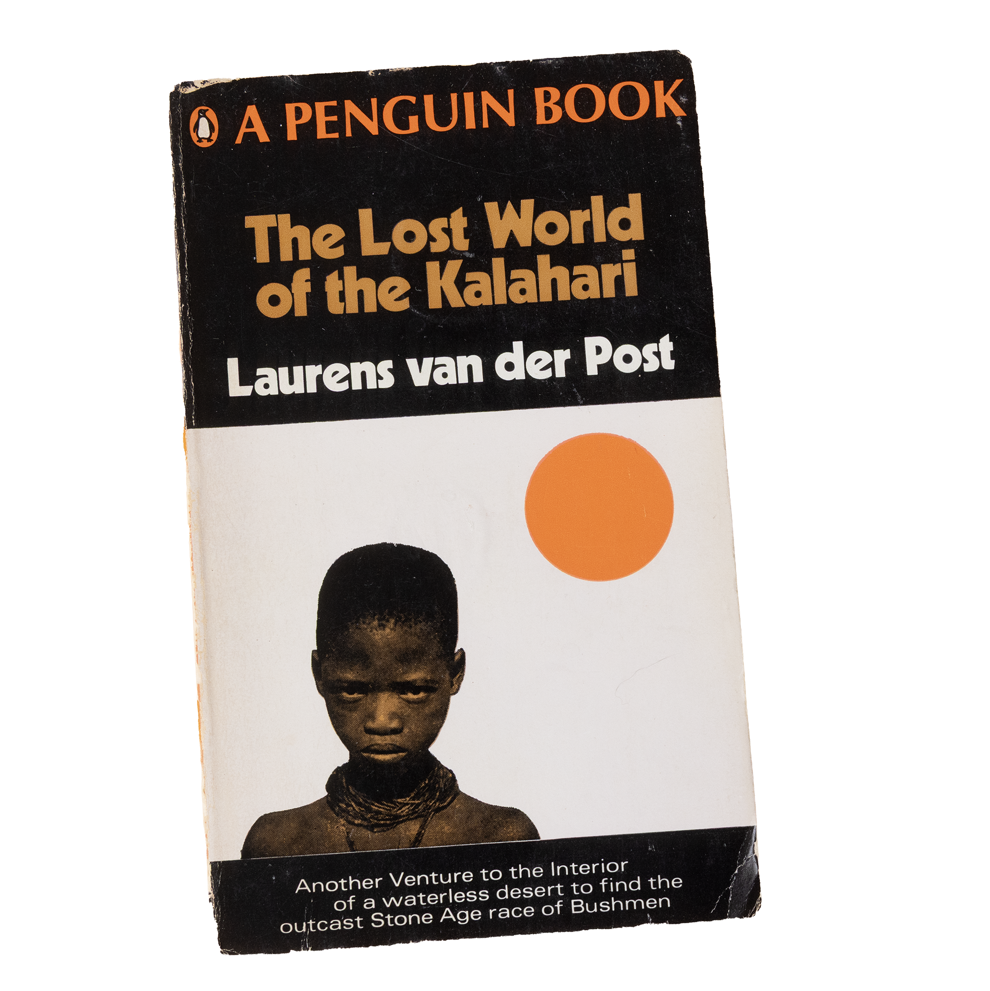 A vintage book cover titled "The Lost World of the Kalahari" featuring a black background with orange, beige, and black circles and a black and white photograph of a person with dark skin, wearing traditional jewelry.