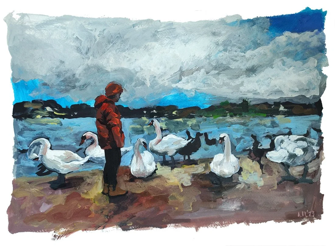 A person in a red jacket and orange hat standing on a lakeshore surrounded by swans and ducks, with a cloudy sky and distant land across the water.