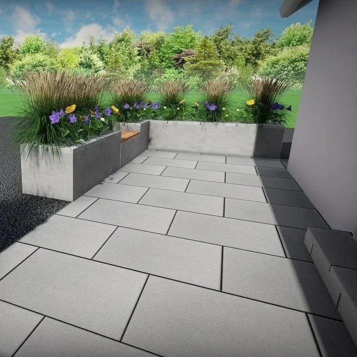 Modern patio with large light gray tiles, built-in concrete planter with purple and yellow flowers, green bushes, and trees in the background.