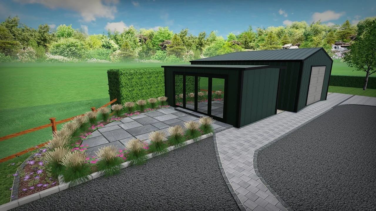 A modern dark green shed with large glass doors and a garage door, surrounded by a stone pathway, garden plants, and a green landscape background.