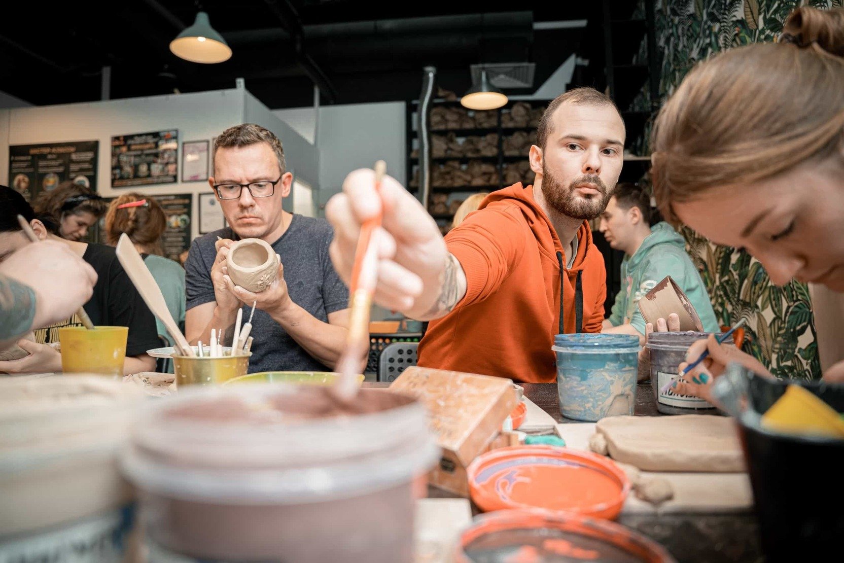    a man sculpts from clay   