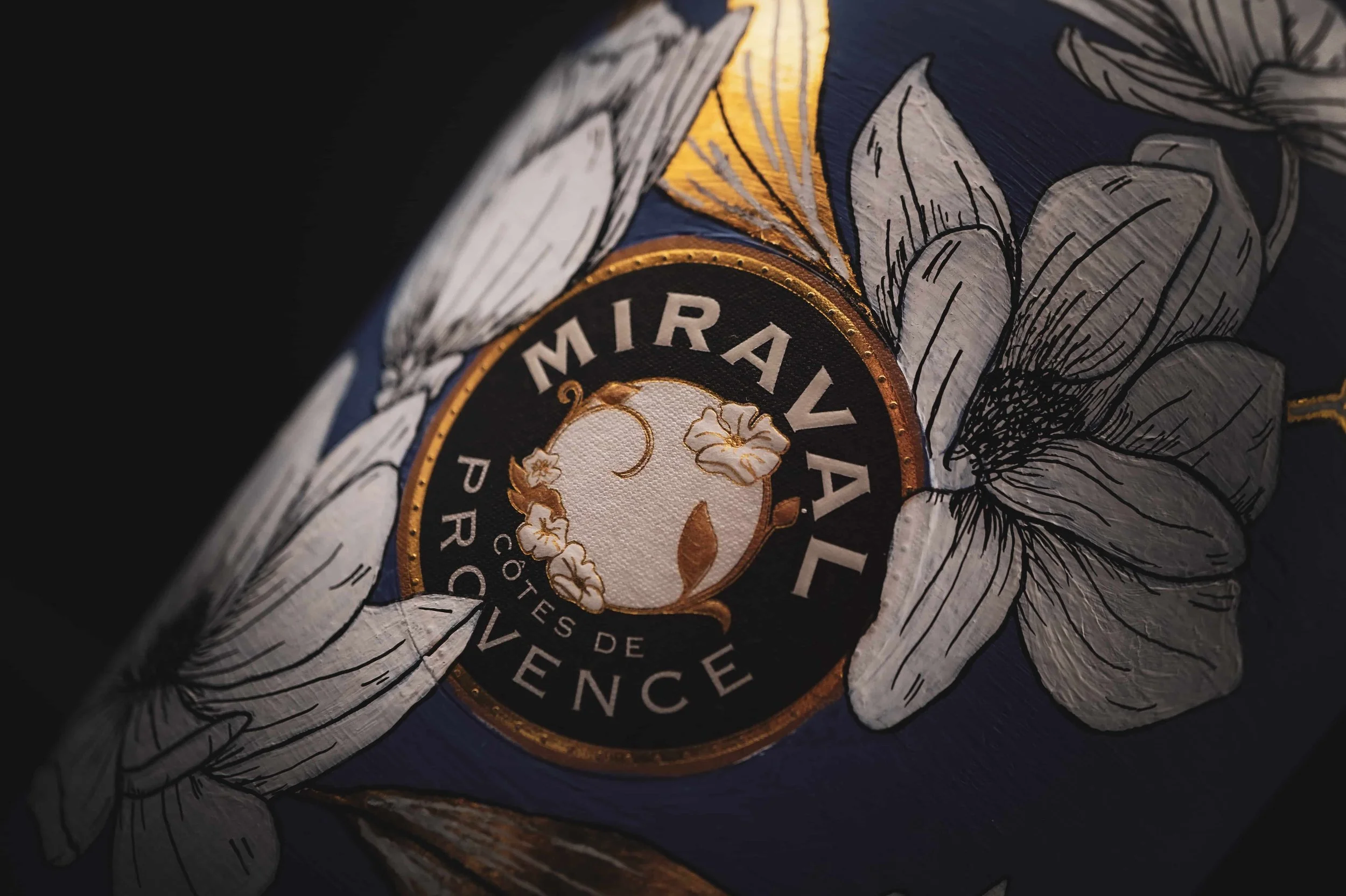 Close-up of hand-painted floral and gold detail on a Miraval Côtes de Provence bottle
