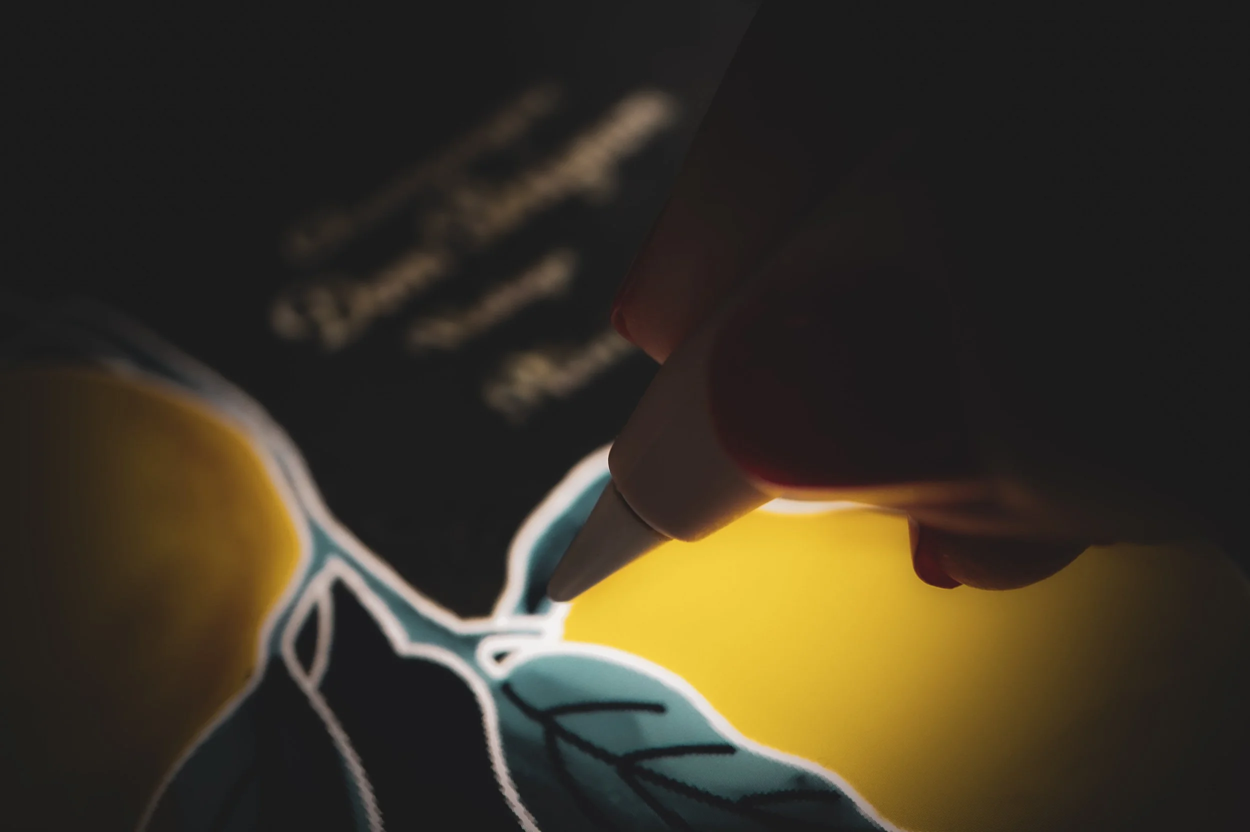 Artist designing a bottle design as digital mockup with Apple Pencil