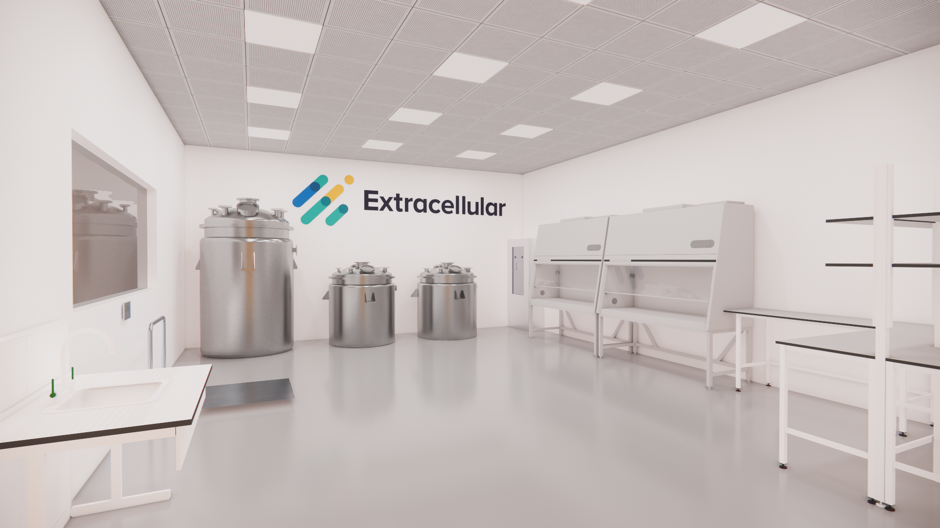 Extracellular's pilot manufacturing scale-up facility in Bristol. A laboratory with stainless steel tanks, white workbenches, shelves, and a wall with the logo 'Extracellular' in black text and a colourful abstract design.