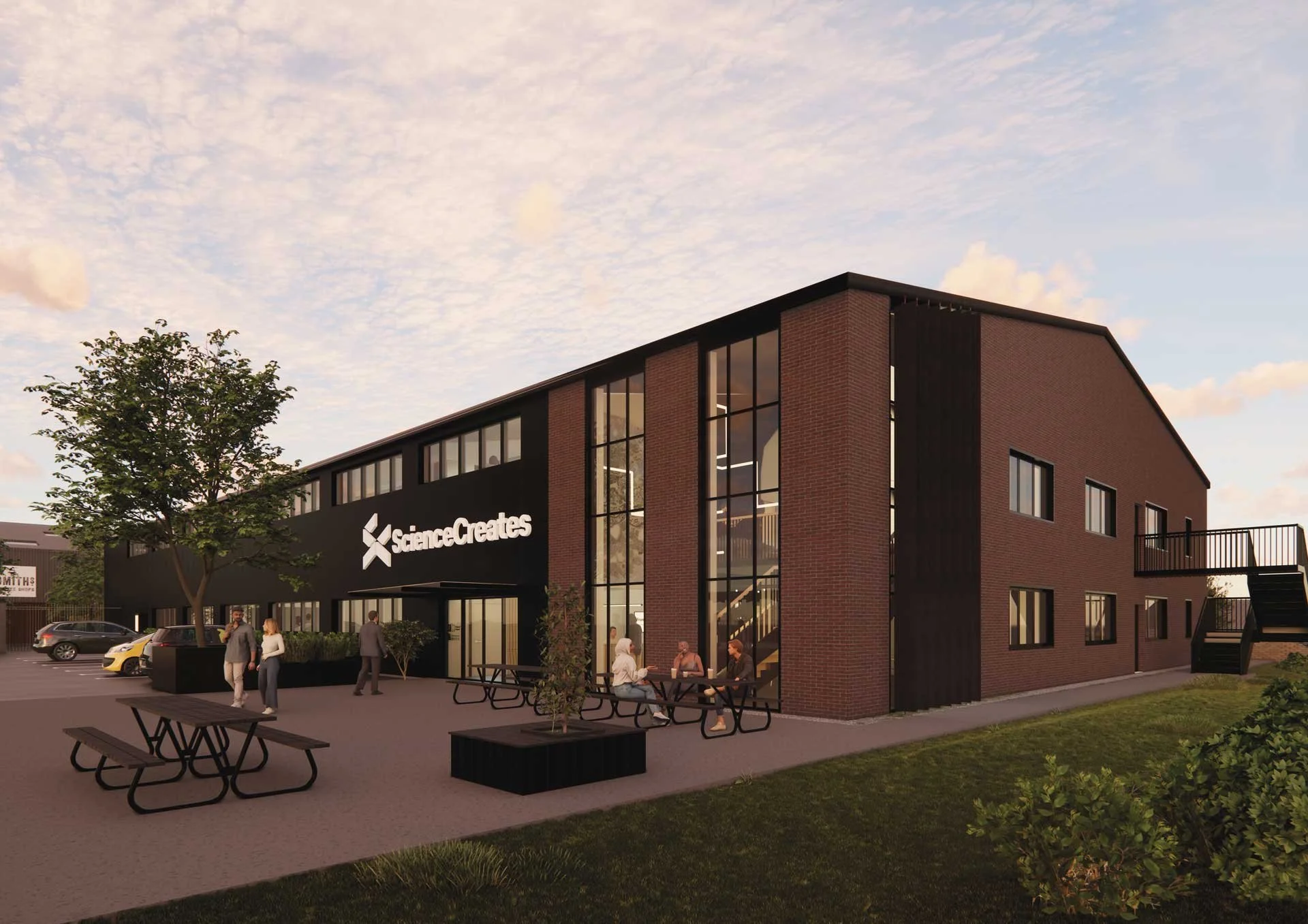 Rendering of Science Creates OMX - a modern two-story Deep Tech Incubator in Bristol, with containment-level 2 laboratories and a warehouse-to-lab conversion. Outdoor seating and a parking lot, under a partly cloudy sky.