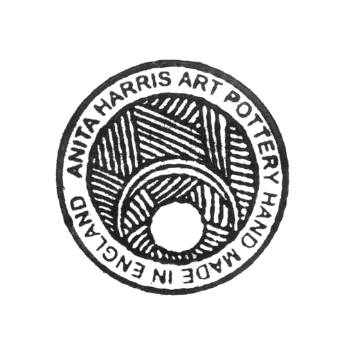 Circular embossed stamp with text around the edge and stylized hands or shapes in the center.