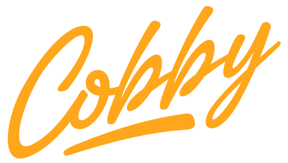 Der Schriftzug 'Cooking' in orange, handgeschriebenes Design auf schwarzem Hintergrund.
