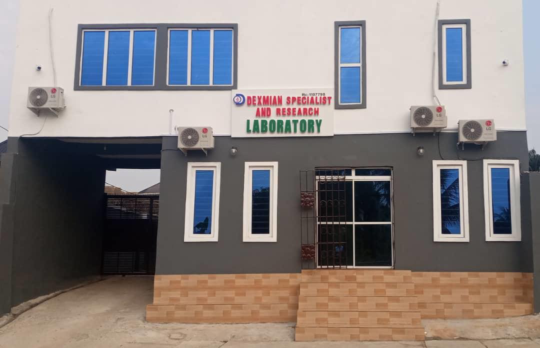 Front view of a building with a sign that reads 'Dexamian Specialist and Research Laboratory' and five air conditioning units mounted on the exterior wall.