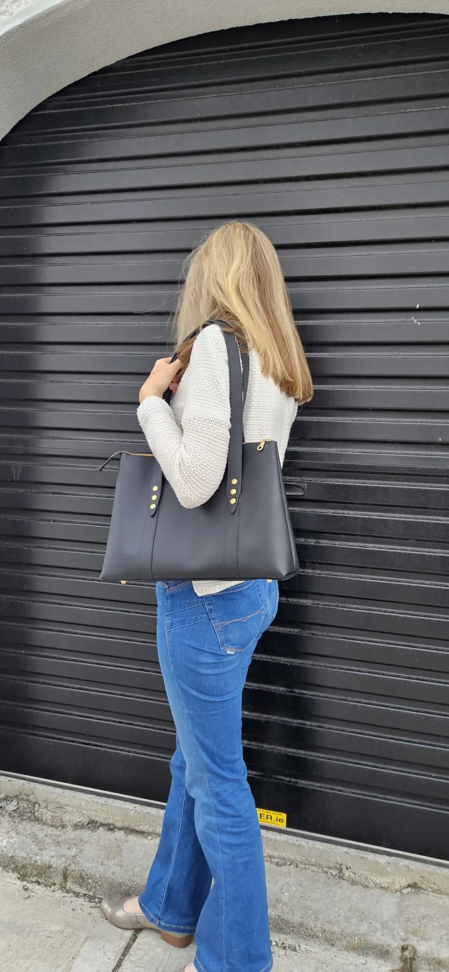 Black zippered tote worn over shoulder, Meadow & Hide.JPG