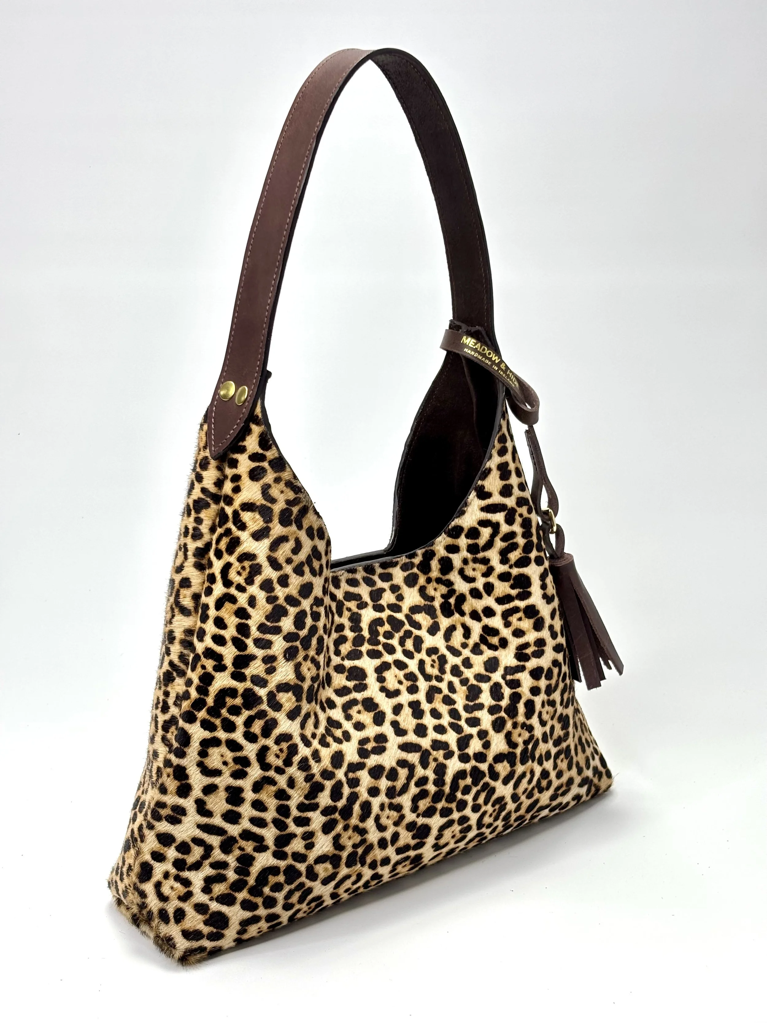 Leopard print hobo style handbag from Meadow and Hide with brown leather straps and tassel details