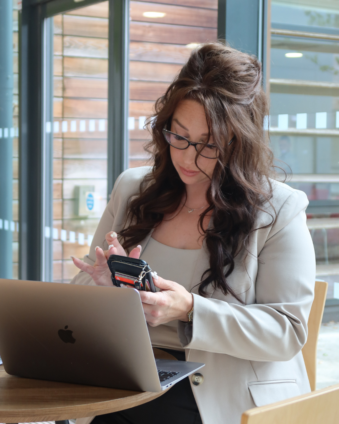 Sarah the founder of Connect The Dots, sits at her desk working on seo and website builds and designs for clients.