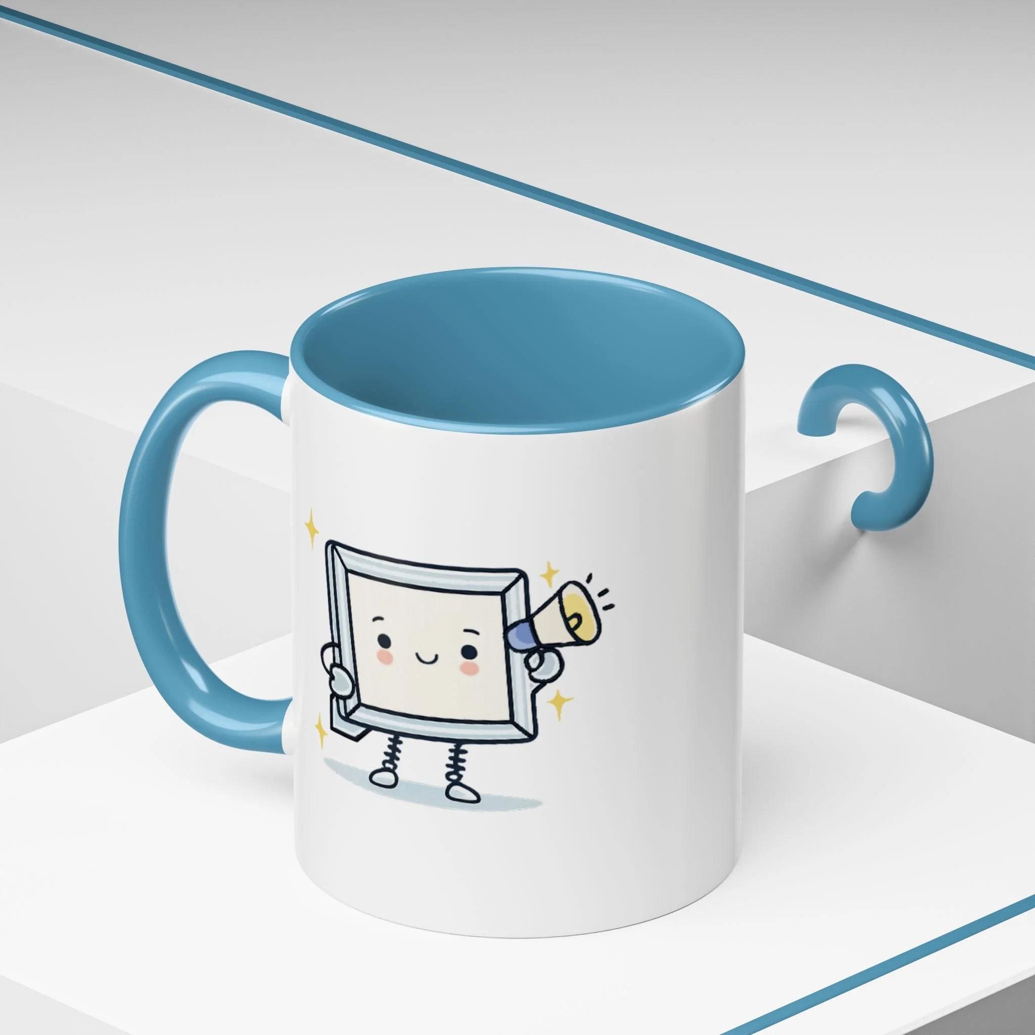 White mug with blue handle and interior, featuring a cartoon character of a smiling picture frame with arms, legs, and a megaphone, on a white surface with a blue line in the background.