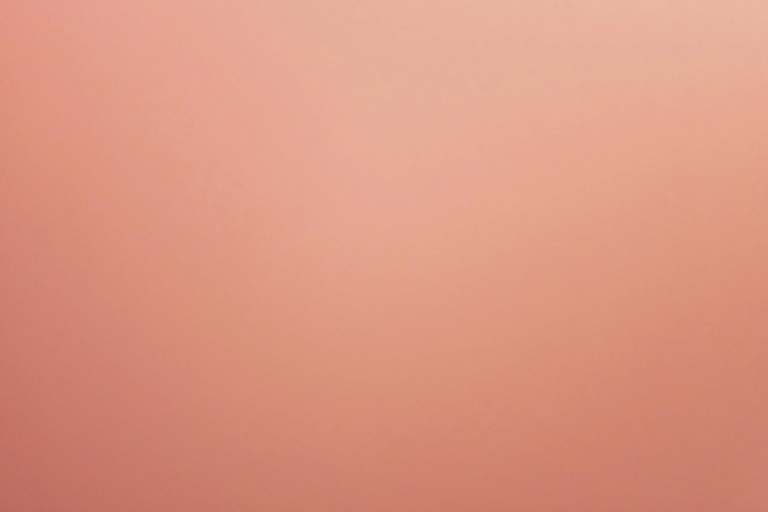 a plain pink background with no distinct objects or details