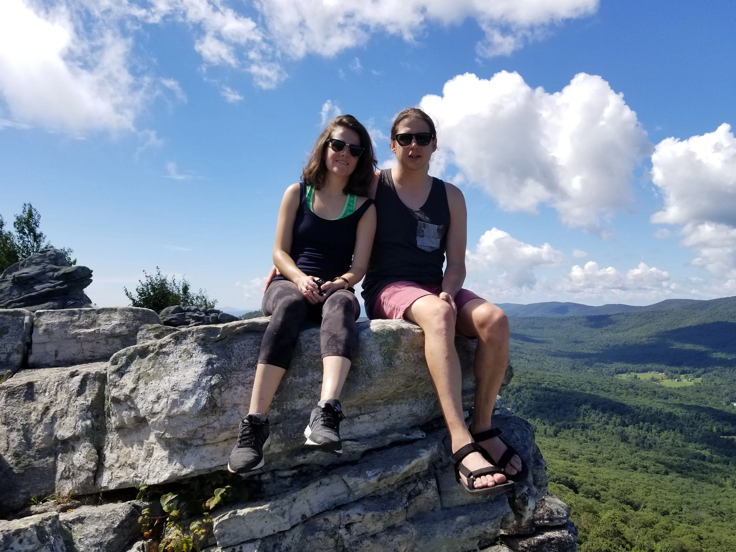 Couple sitting on a rock at Big Schloss, in George Washington National Forest