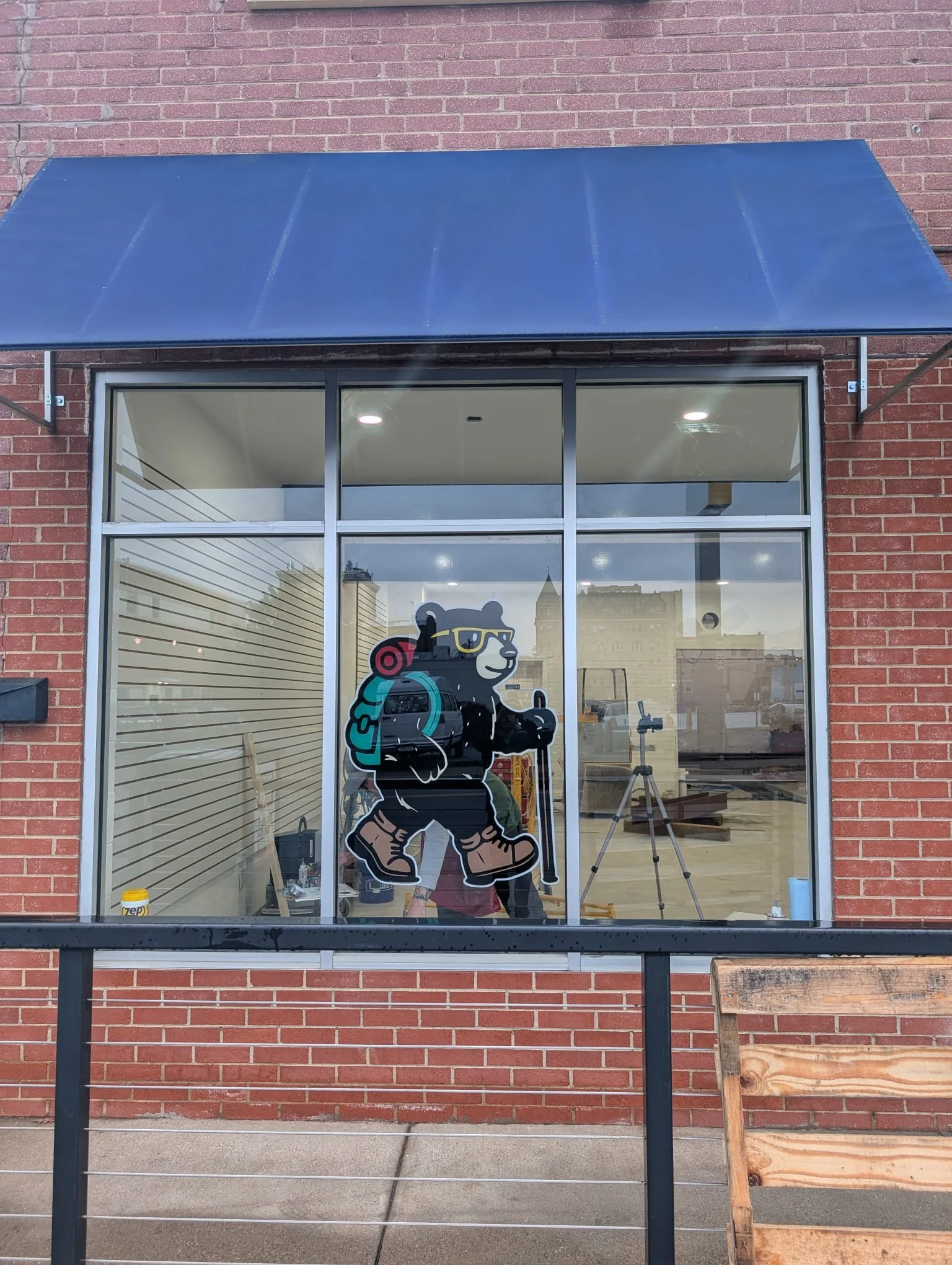 Bear, Outsider logo, painted on window at store facade