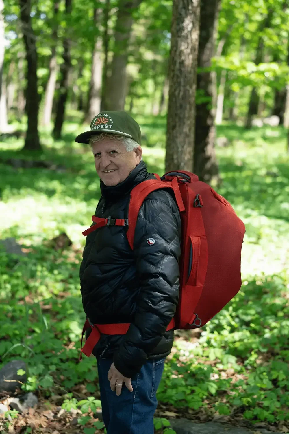 Older man wearing a used Big Agnes jacket and a Landmark Project hat