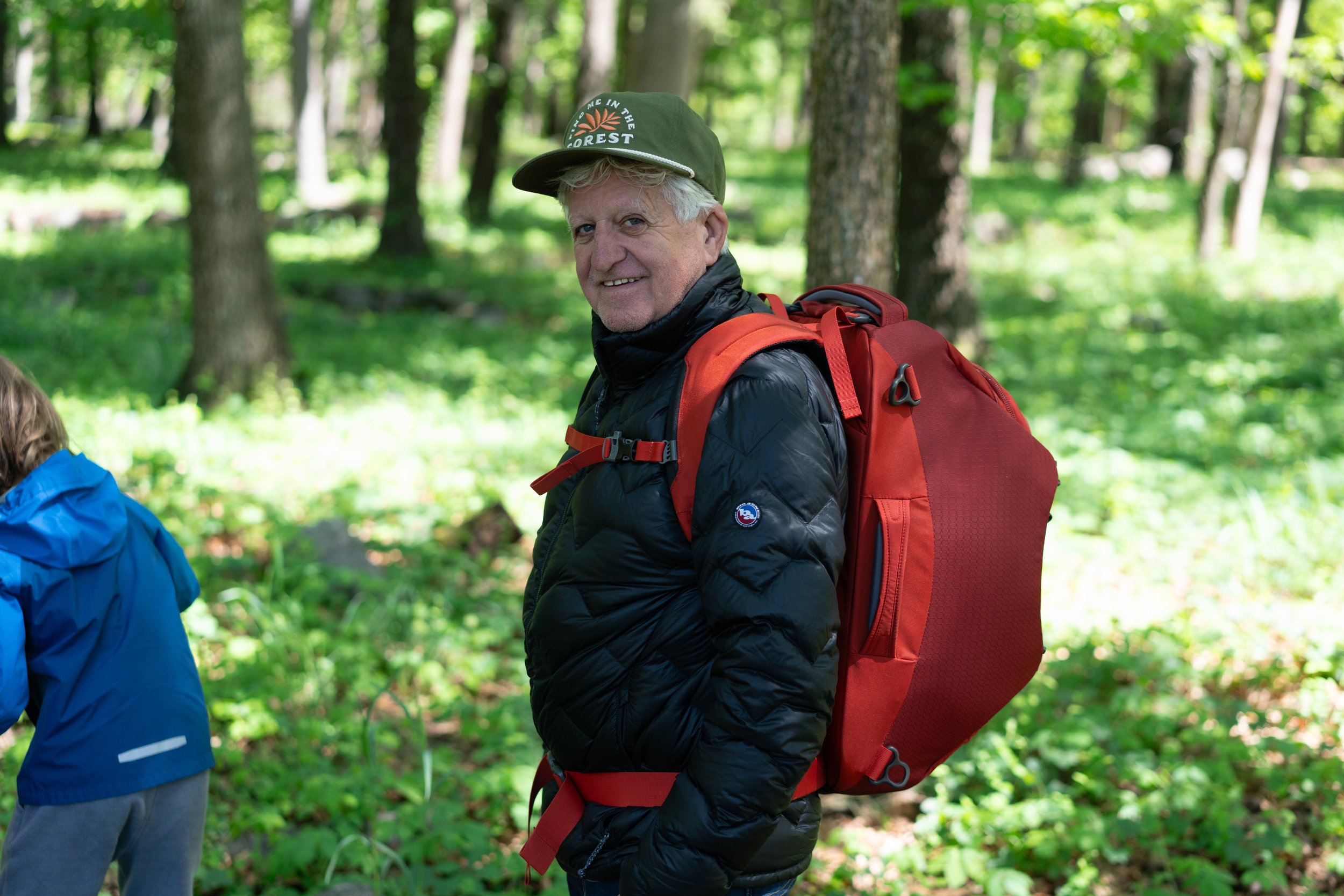 Older man wearing a used Big Agnes jacket and a Landmark Project hat
