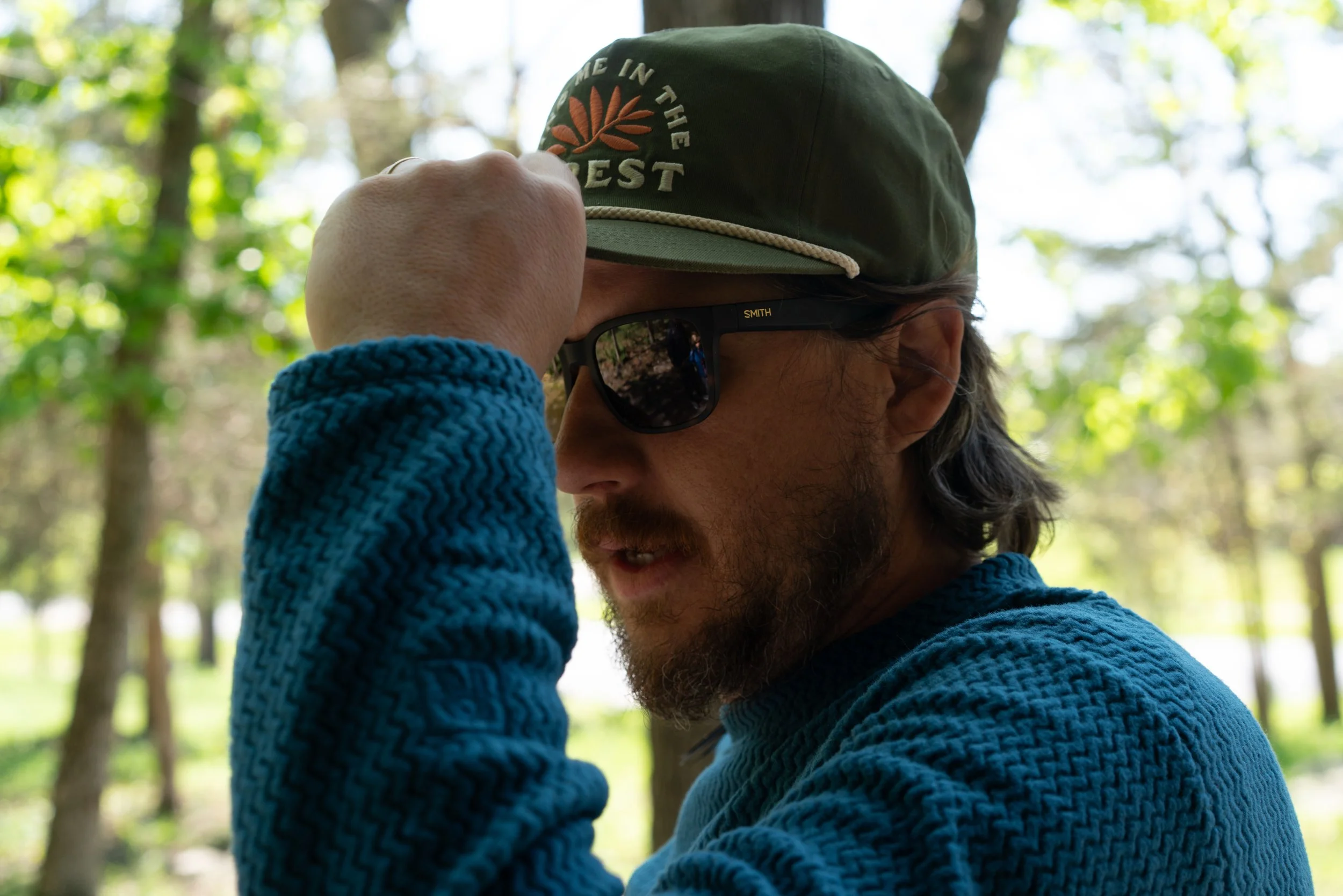 Man wearing Smith sunglasses and Landmark Project hat