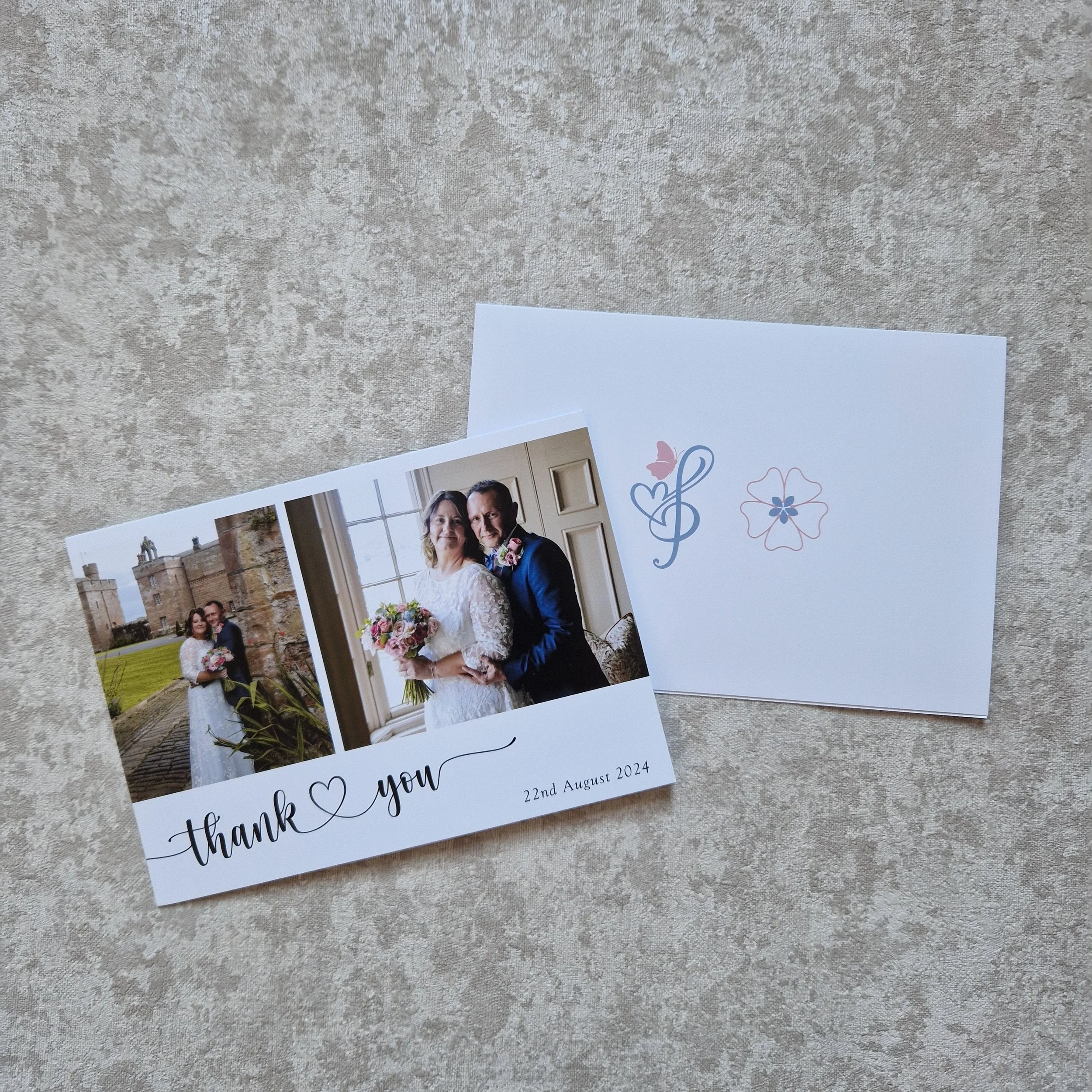 Wedding thank you card with two photos of a couple, one outside in front of a castle and one indoors by a window, both holding bouquets. The card has the text 'thank you' with a heart. Rose Castle Dalston Carlisle Cumbria