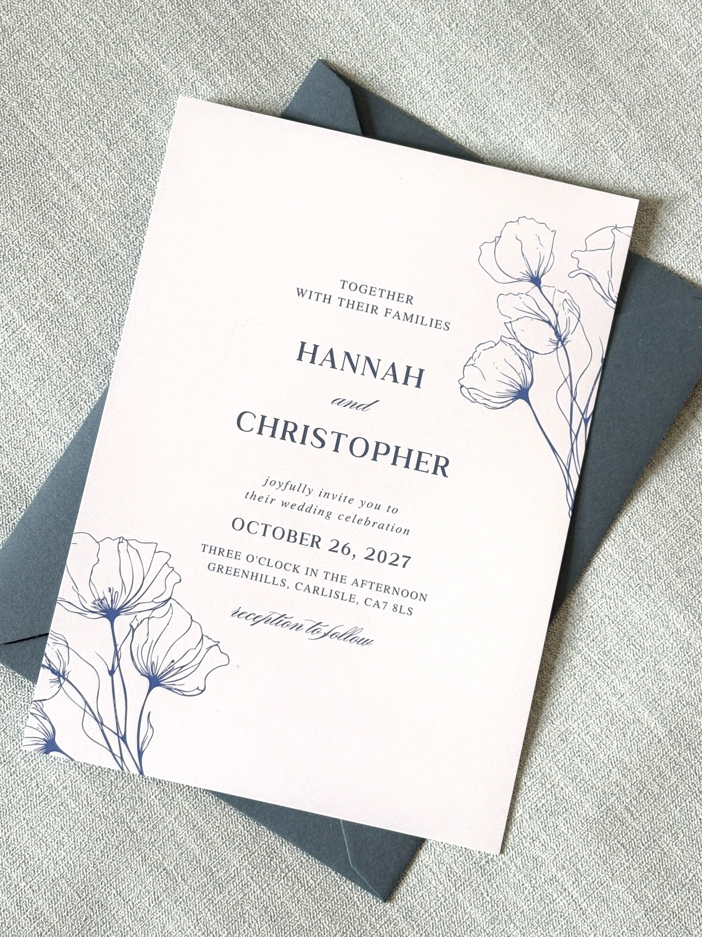 Wedding invitation card with floral illustrations, saying Hannah and Christopher, October 26, 2027, Greenhills, Carlisle, Cumbria