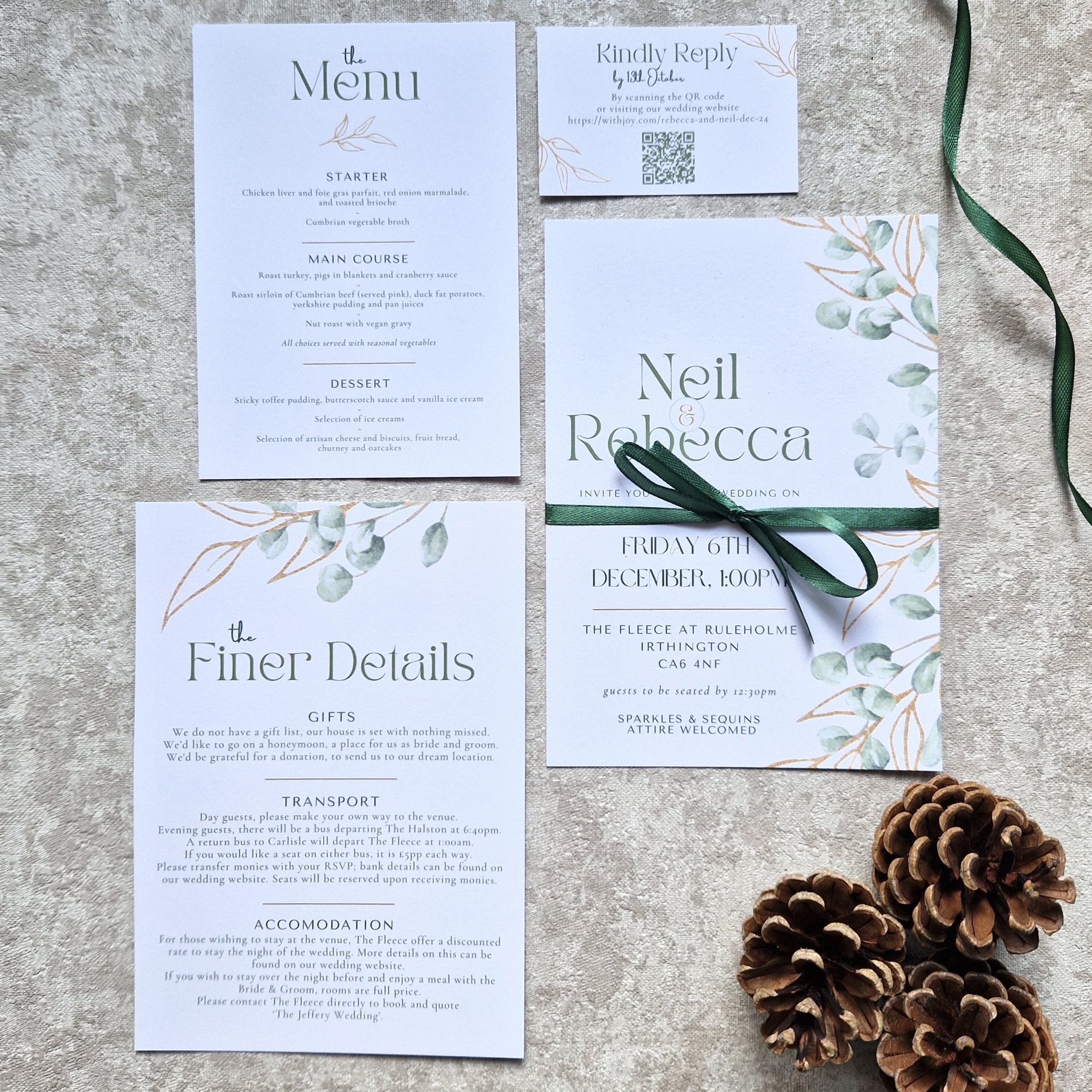 Wedding invitation suite with a main invitation card, a menu card, a details card, a RSVP card, and a green ribbon tied around the main invitation. The set includes accents of eucalyptus leaves and a pine cone decoration.