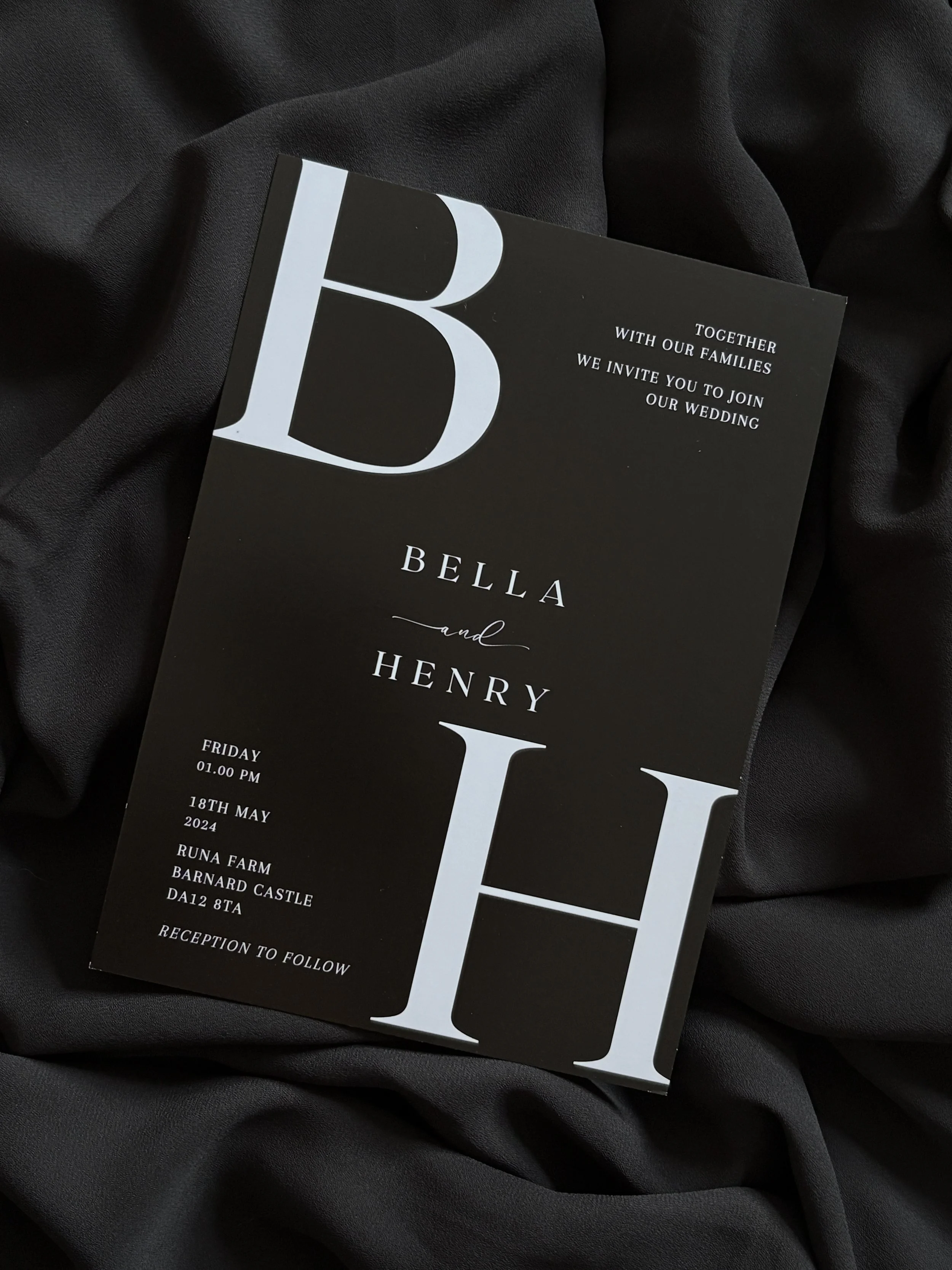 Minimalist Wedding invitation with black background and large white initials 'B' and 'H' for Bella and Henry, displaying event details including date, time, location, and reception information.