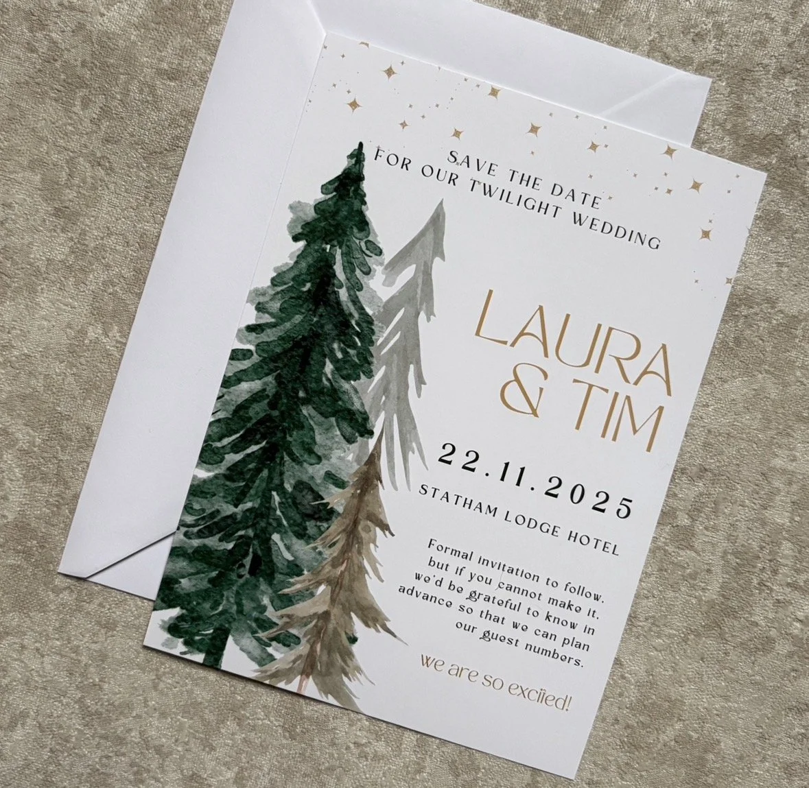 Save the date wedding invitation featuring watercolor evergreen trees and gold accents, for Laura and Tim's wedding on November 22, 2025, at Statham Lodge Hotel.