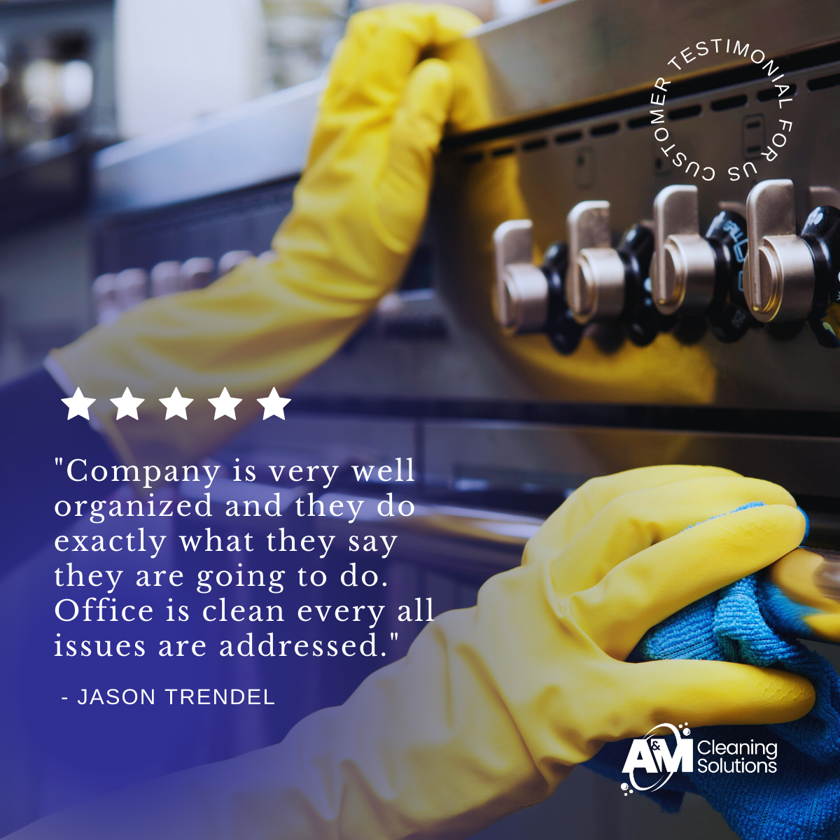 Close-up of a person wearing yellow cleaning gloves using a cloth to clean a stainless steel stove with control knobs.