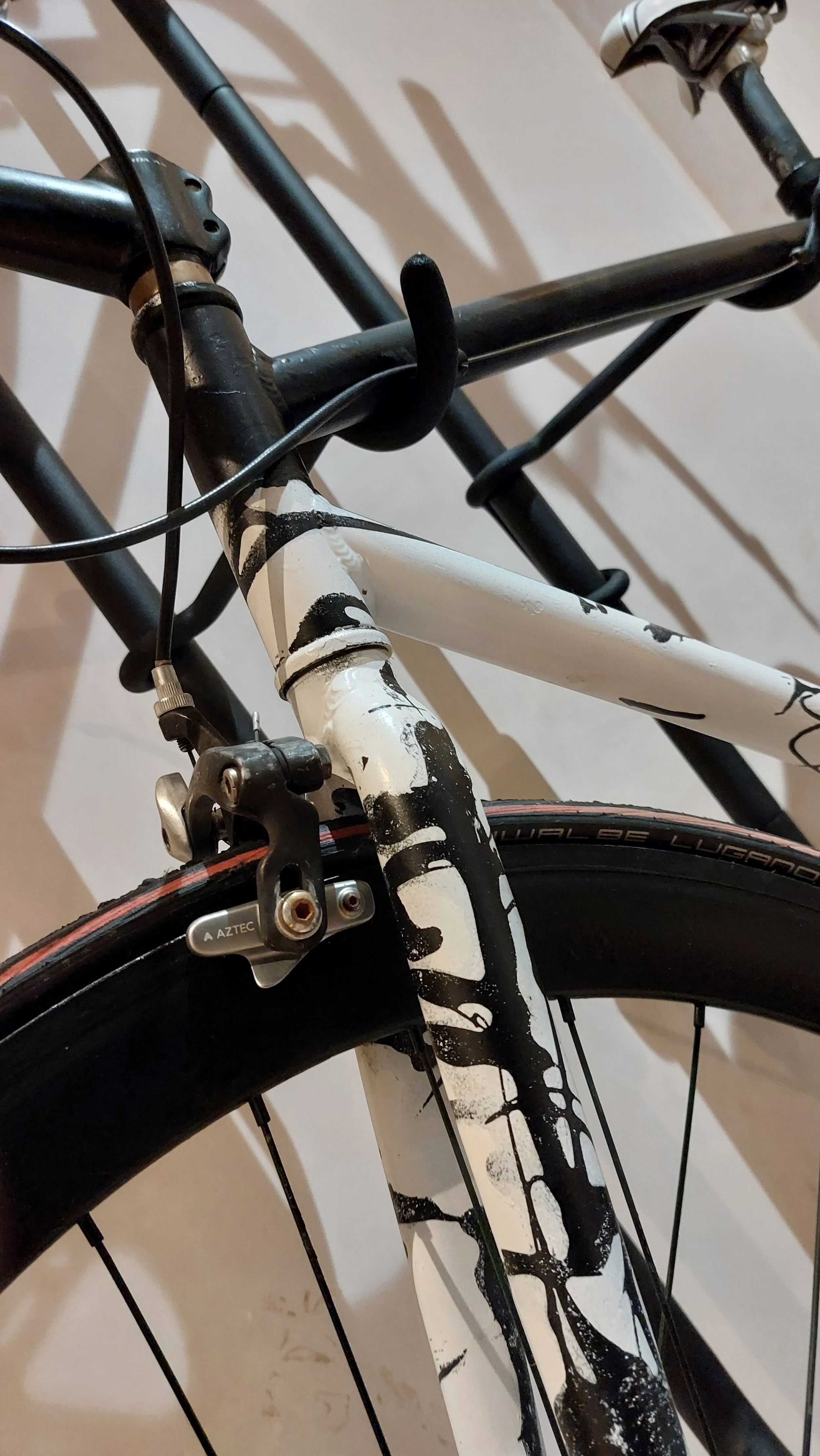 Close-up of a black and white racing bike. With our custom dribble style