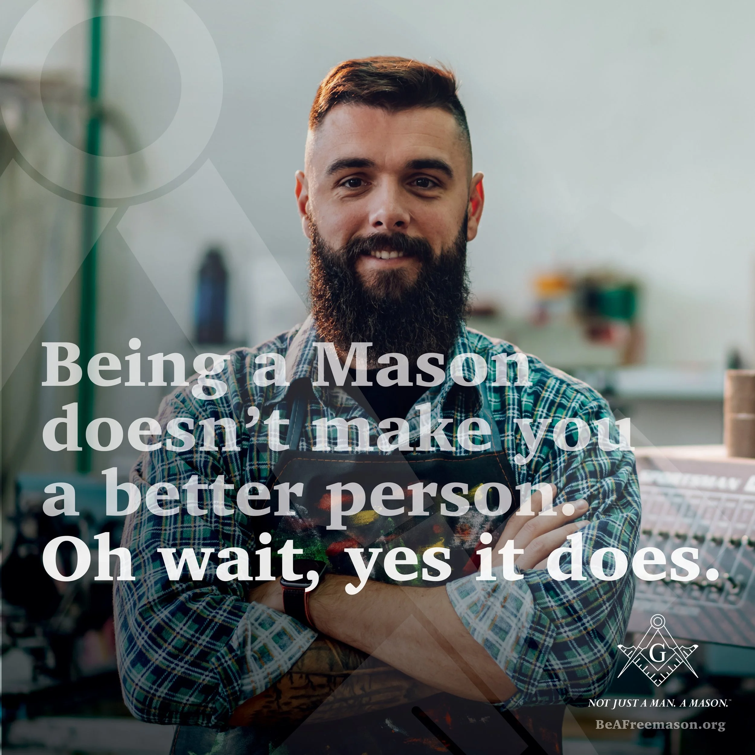 A smiling bearded man in a plaid shirt standing with arms crossed in a workshop or studio, with a quote overlay about Masonry.