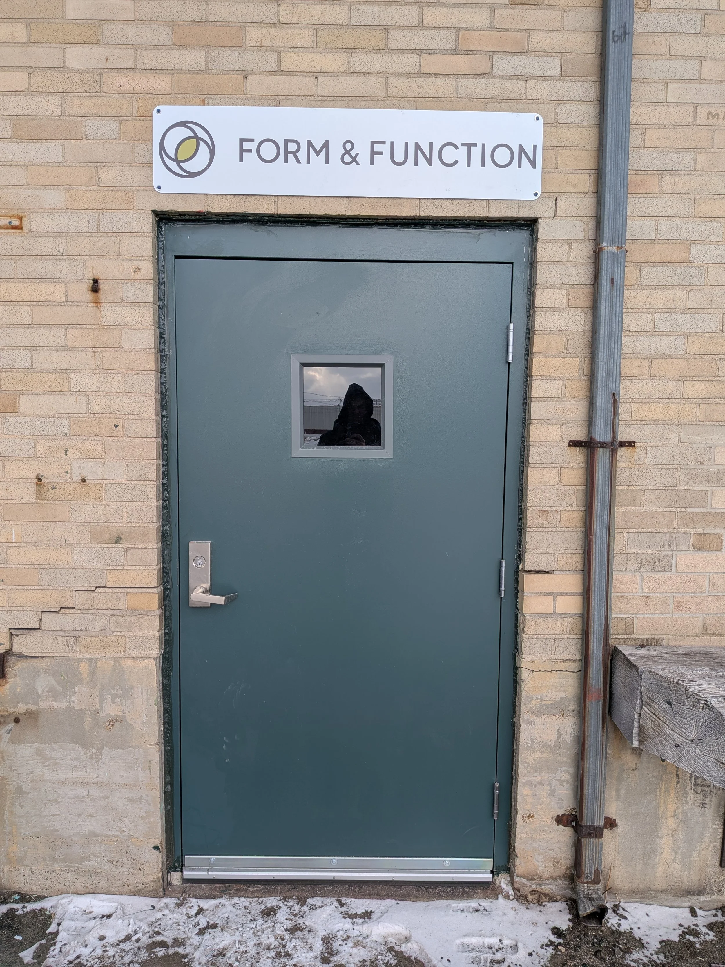 Door to Form and Function Pilates as seen from the parking lot on Clinton Street in Buffalo, New York. Form and Function offers small group reformer Pilates classes.