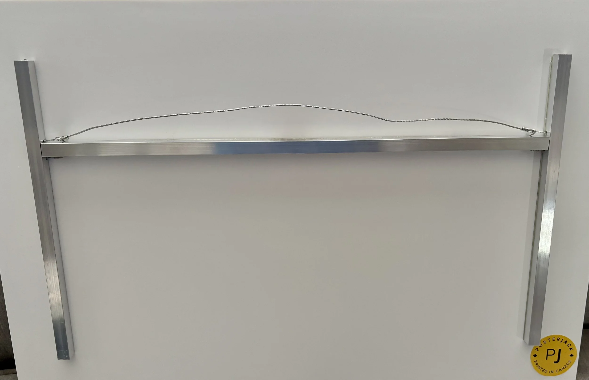 Example of float mount on photoboard, hanging across the top, secured to the sides of the frame.