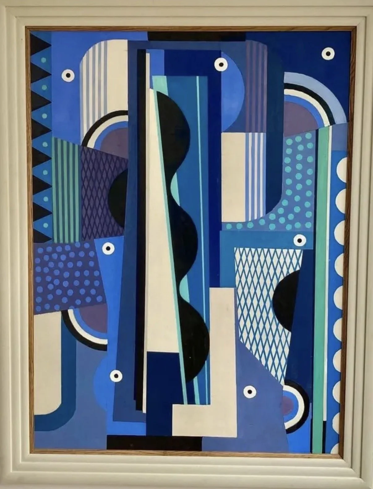 An abstract geometric painting featuring various shapes and patterns in blue, black, white, green, purple, and gray, framed with a white border.